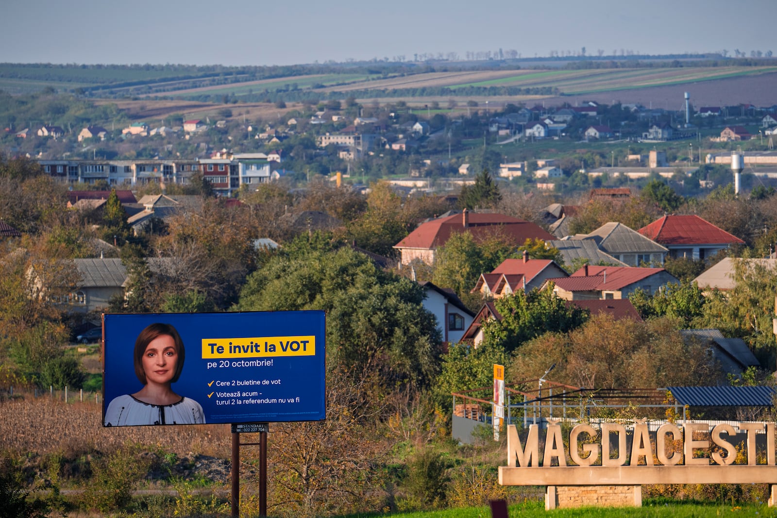 A poster of Moldova's President Maia Sandu that reads "I invite you to vote" is placed on the side of the road in Magdacesti, Moldova, Thursday, Oct. 17, 2024, ahead of a presidential election and a referendum of whether to enshrine in Moldova's Constitution its path to European Union membership taking place on Oct.20. (AP Photo/Vadim Ghirda)