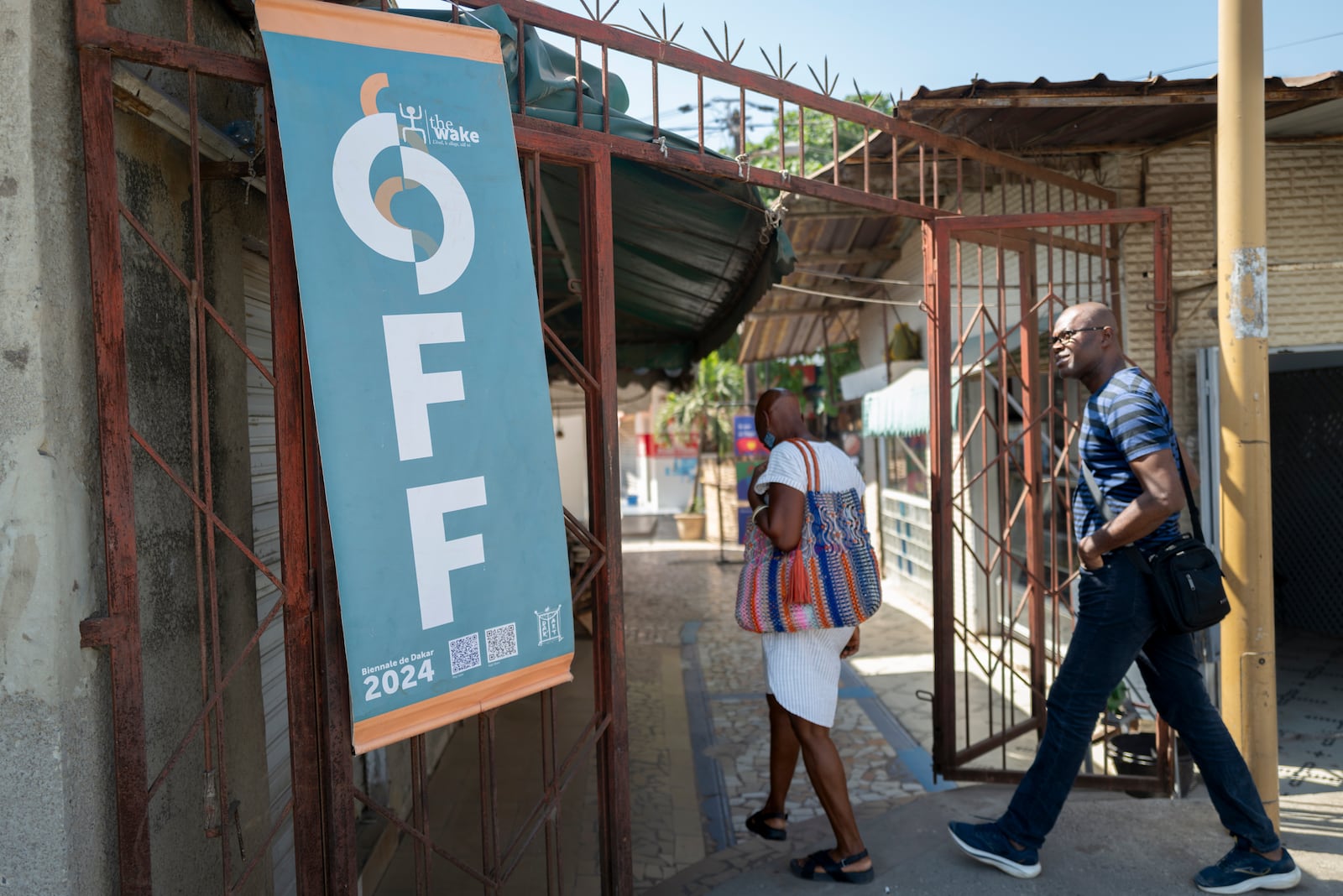 People enterthe Soumbedioune craft market in Dakar, Senegal, Thursday, Nov. 28, 2024. (AP Photo/Sylvain Cherkaoui)