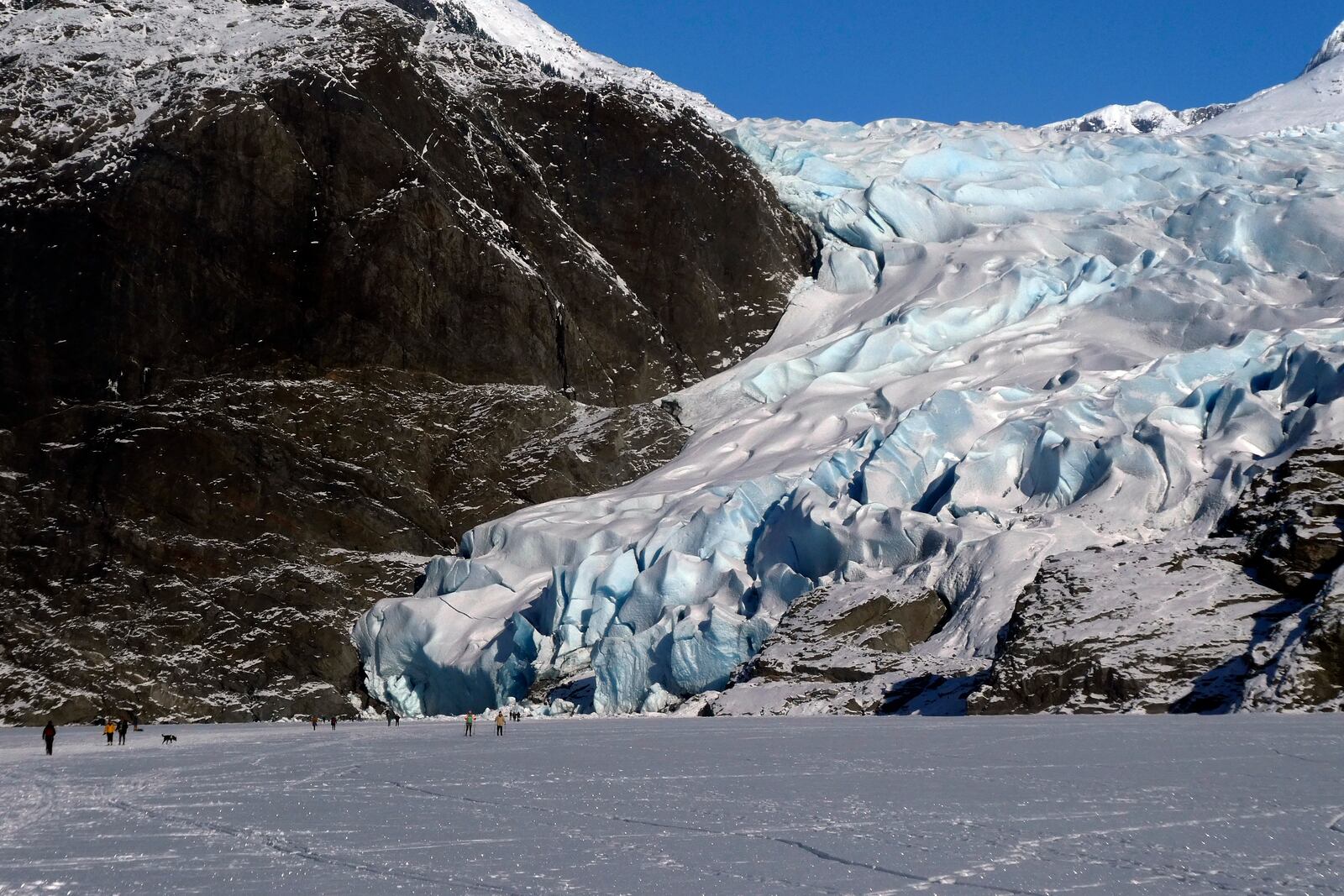 FILE - People walk near the Mendenhall Glacier on Feb. 9, 2025, in Juneau, Alaska. (AP Photo/Becky Bohrer, File)