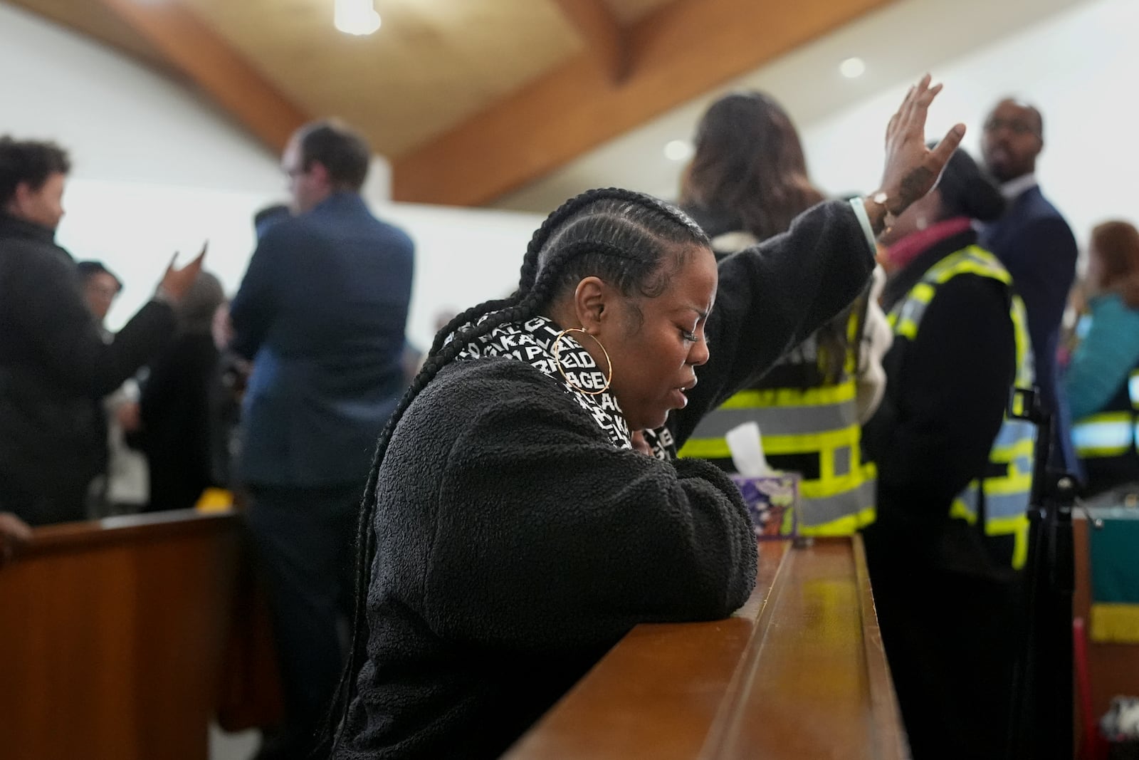 A woman prays during a vigil for students that were killed and injured in a school shooting, Wednesday, Jan. 22, 2025, in Nashville, Tenn. (AP Photo/George Walker IV)