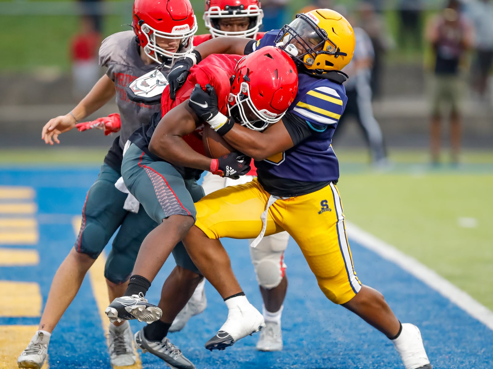 Springfield High School senior linebacker Kyron Dolby tackles a Cincinnati Princeton player in the end zone during their scrimmage game on Aug. 15 in Springfield. Michael Cooper/CONTRIBUTED