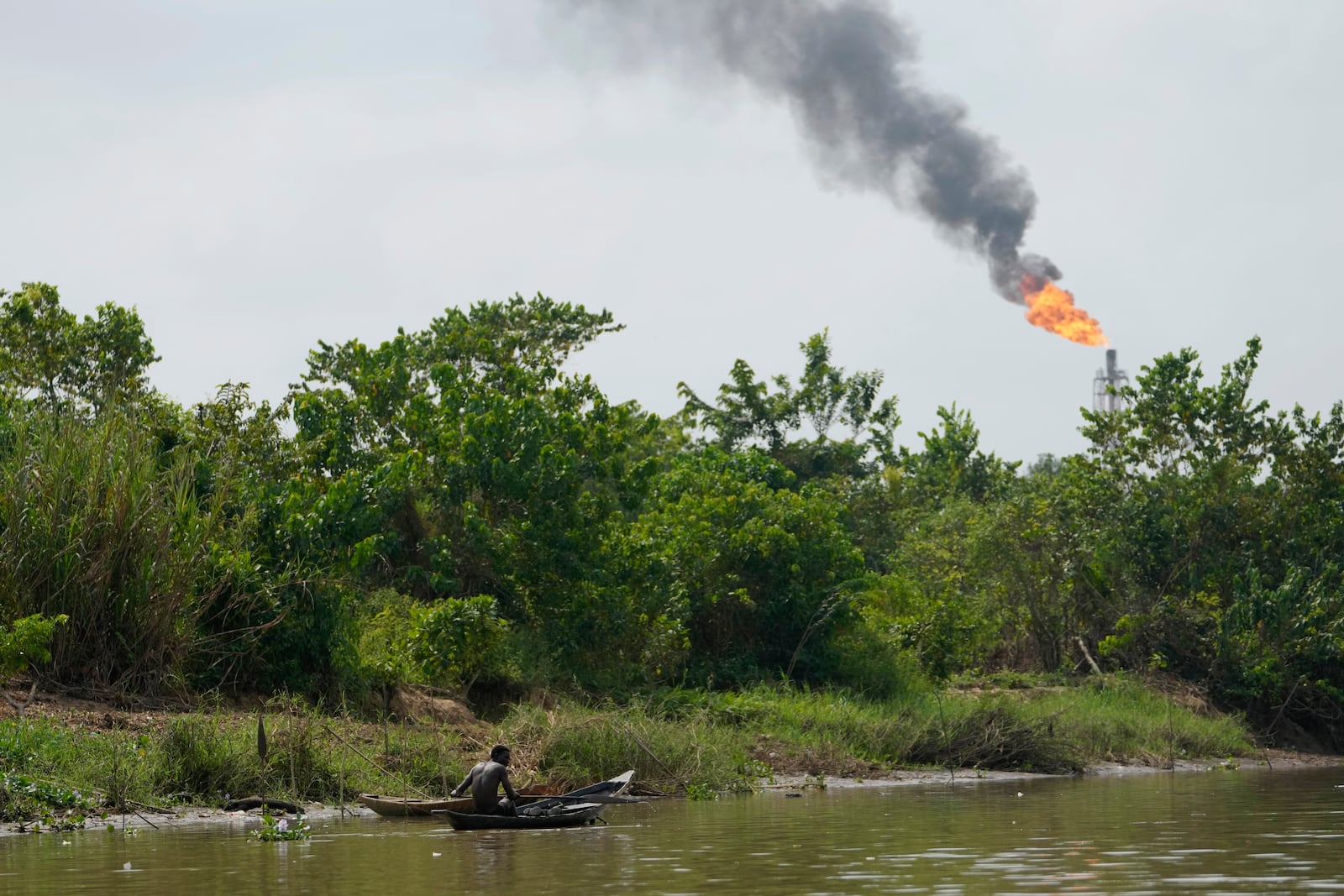 FILE - A man paddles his canoe in the Niger Delta near the village of Ogboinbiri, Nigeria, Dec. 11, 2024. (AP Photo/Sunday Alamba, File)