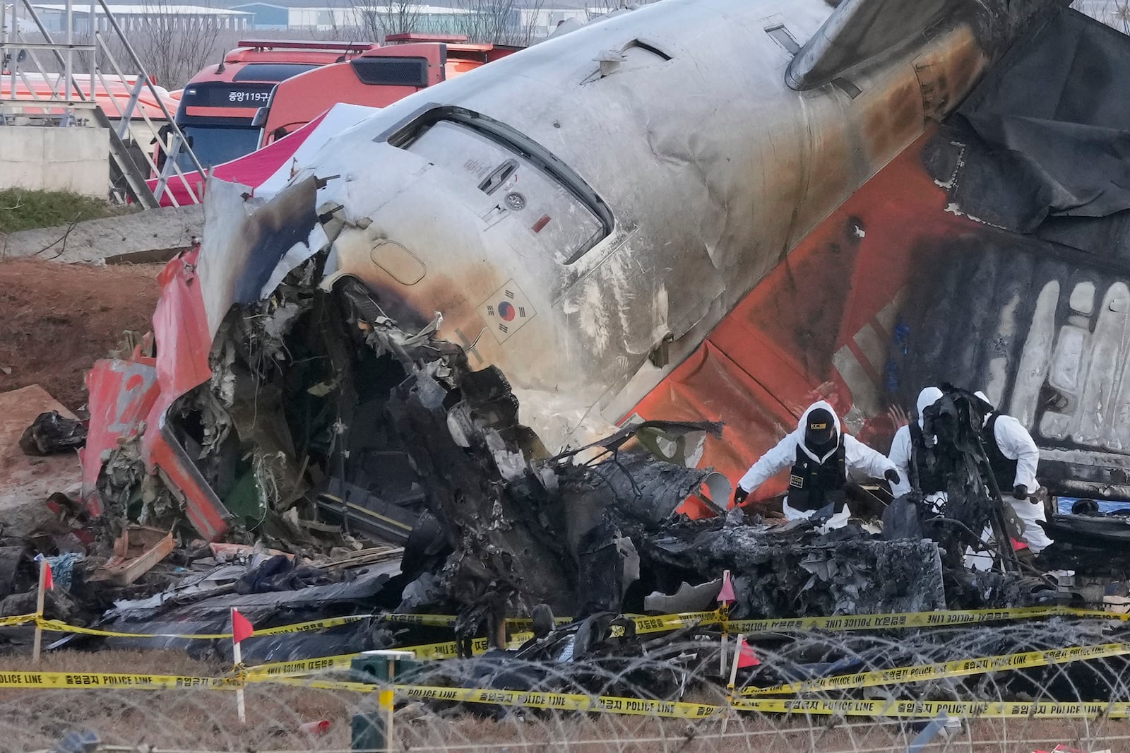 Rescue team members work at the site of a plane crash at Muan International Airport in Muan, South Korea, Tuesday, Dec. 31, 2024. (AP Photo/Ahn Young-joon)