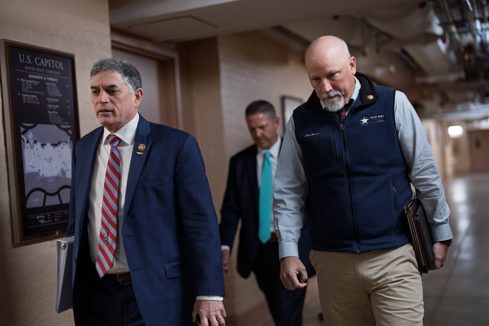 Members of the conservative Freedom Caucus, Rep. Andrew Clyde, R-Ga., left, and Rep. Chip Roy, R-Texas, arrive to meet with Speaker of the House Mike Johnson, R-La., and the Republican Conference as the GOP leadership work to get a spending bill, at the Capitol in Washington, Tuesday, Feb. 11, 2025. (AP Photo/J. Scott Applewhite)