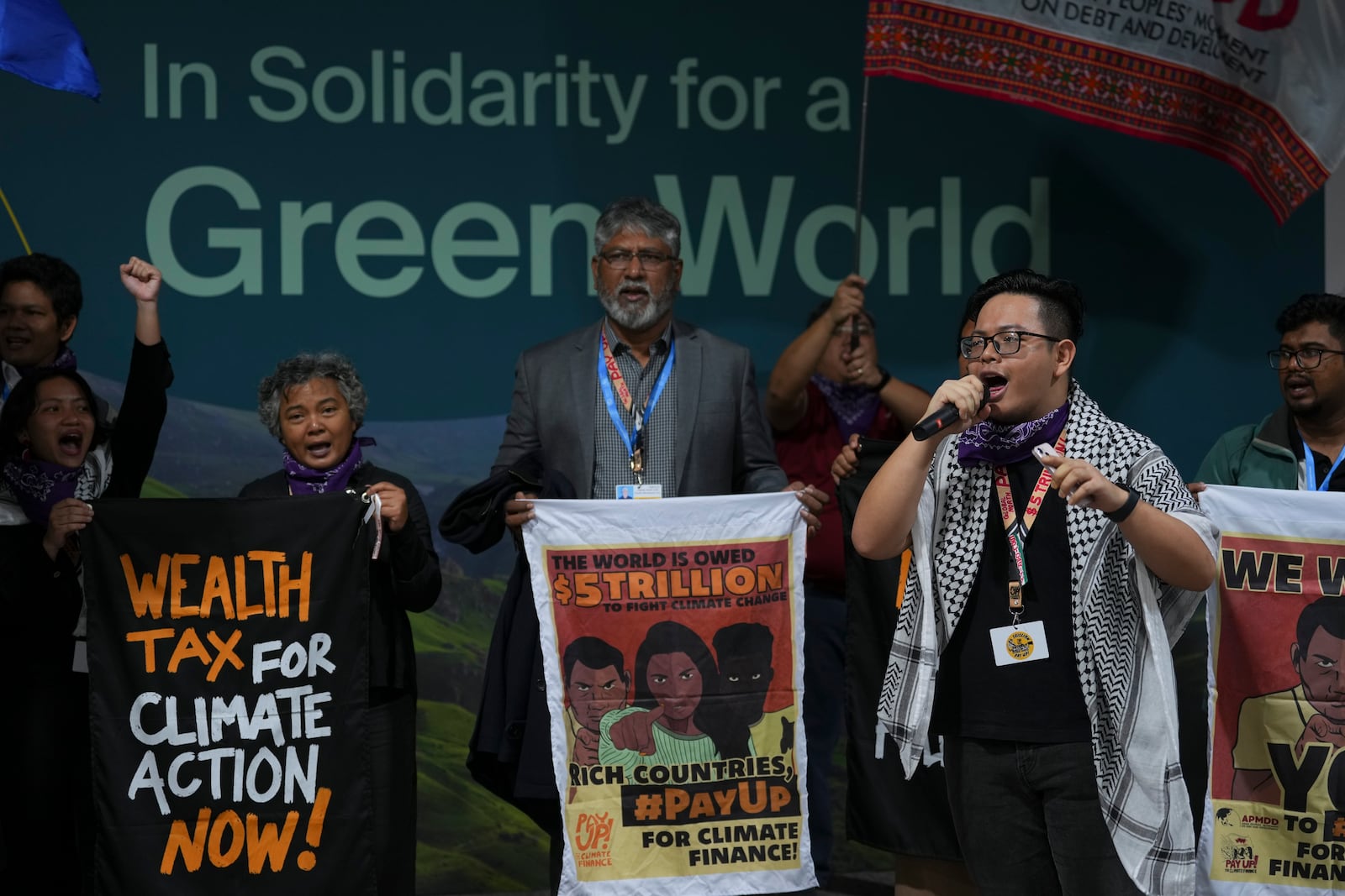 Arnold Jason Del Rosario leads a demonstration on climate finance at the COP29 U.N. Climate Summit, Monday, Nov. 18, 2024, in Baku, Azerbaijan. (AP Photo/Peter Dejong)