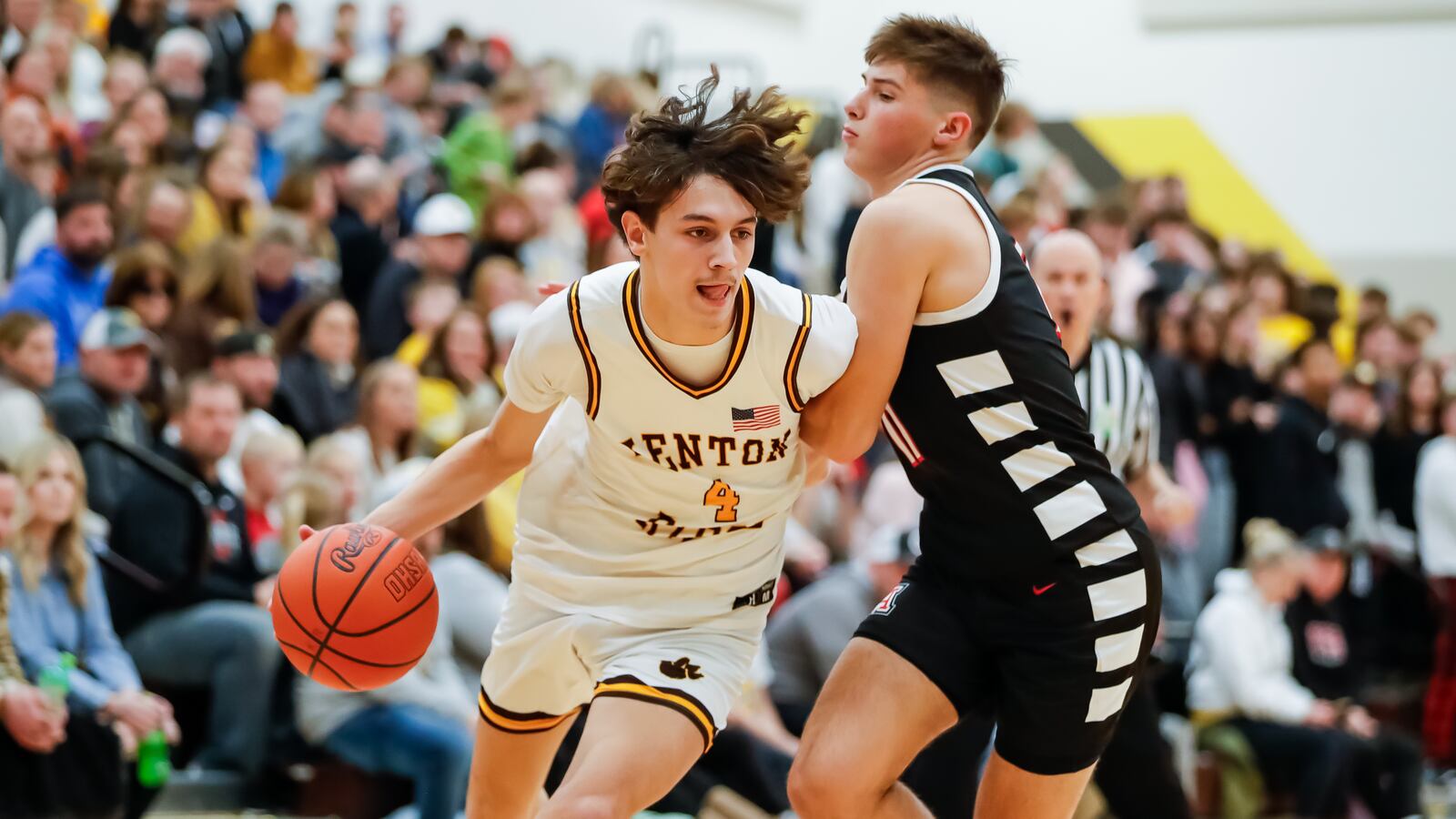 Kenton Ridge High School senior Canye Rogan drives past Jonathan Alder junior Ryan Mark during their game on Friday night in Springfield. Michael Cooper/CONTRIBUTED