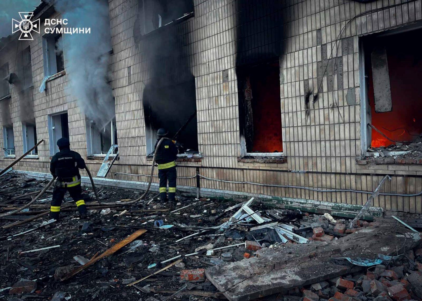 In this photo provided by the Ukrainian Emergency Service on Wednesday, March 19, 2025, firefighters work on a site of a Russian attack in Krasnopillia, Sumy region, Ukraine. (Ukrainian Emergency Service via AP)