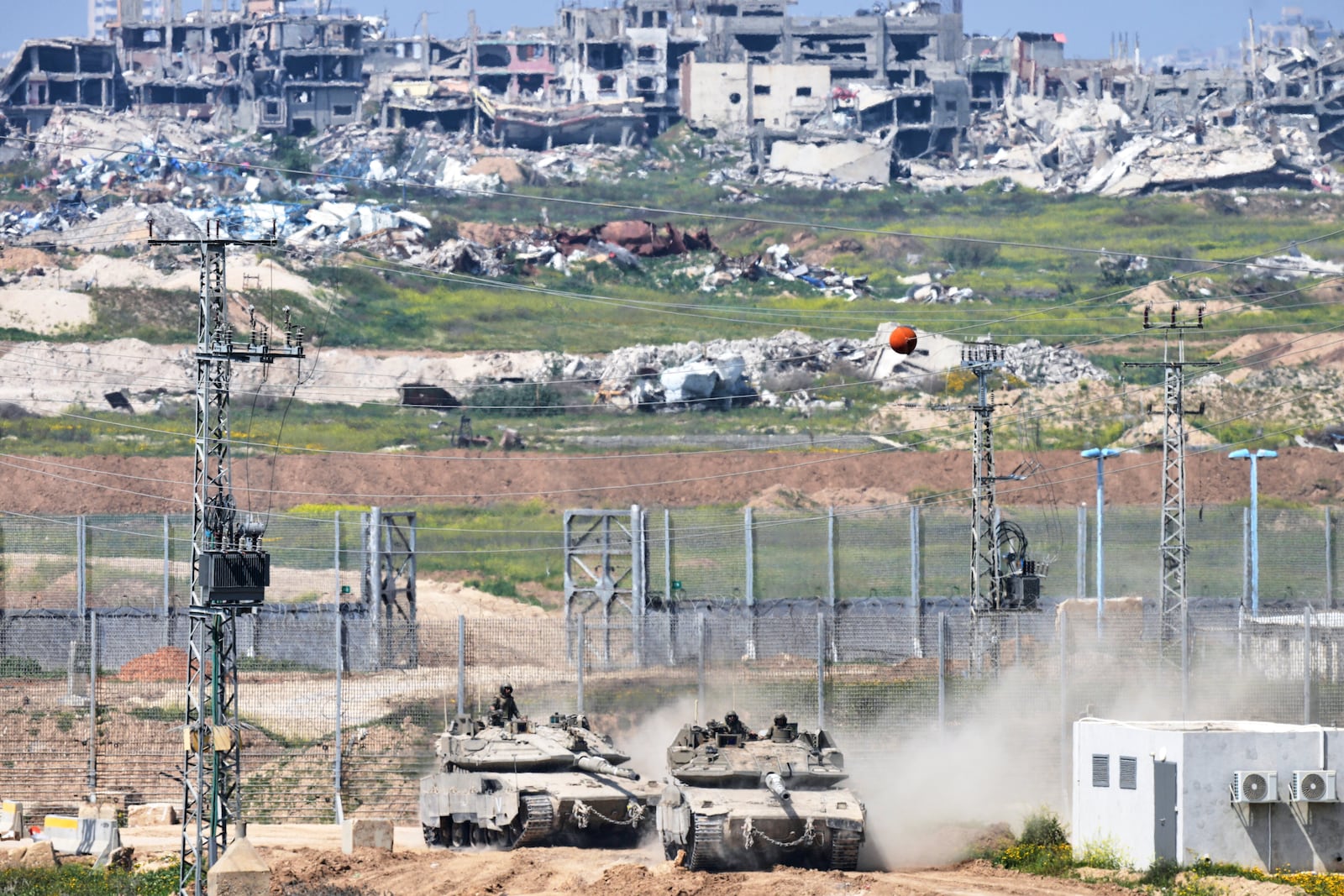 Israeli tanks maneuver on the border with northern Gaza Strip as seen from southern Israel, Tuesday, March 18, 2025. (AP Photo/Ohad Zwigenberg)