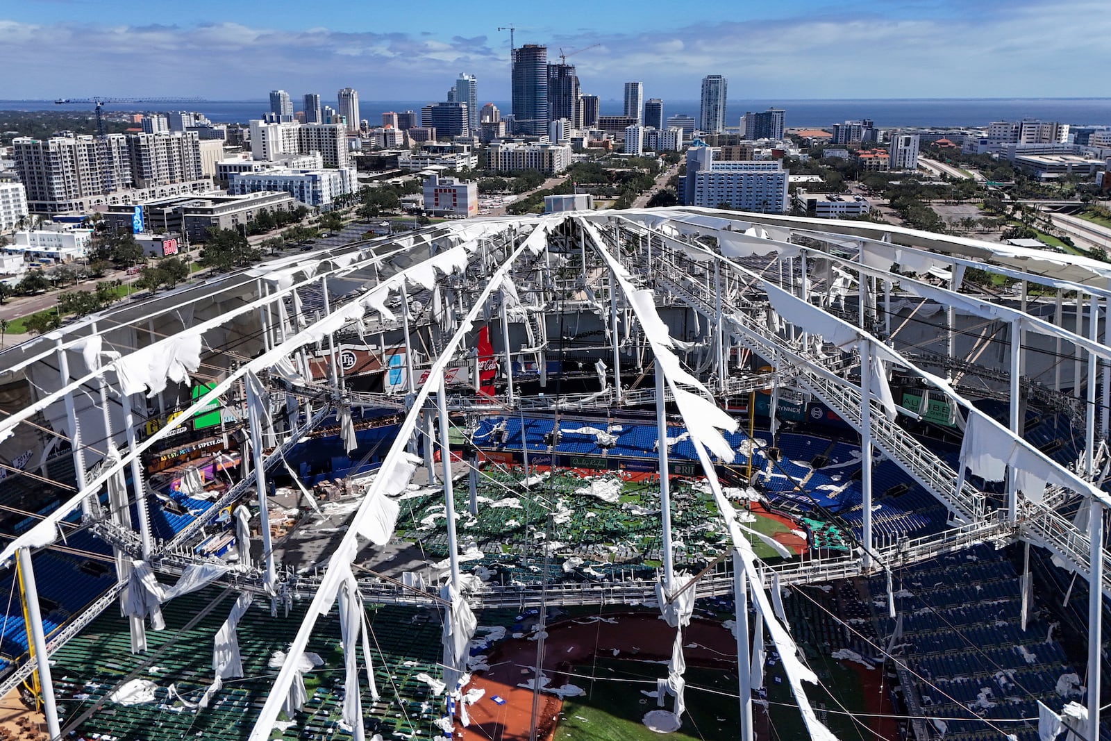 The roof of the Tropicana Field is damaged the morning after Hurricane Milton hit the region, Thursday, Oct. 10, 2024, in St. Petersburg, Fla. (AP Photo/Mike Carlson)