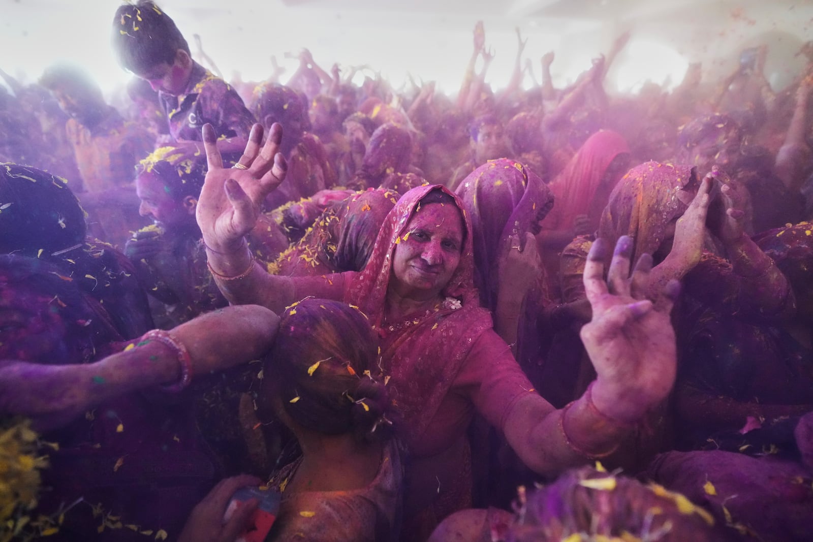 Hindu devotees cheer as they celebrate Holi, the Hindu festival of colors, at the Lord Jagannath temple in Ahmedabad, India, Friday, March 14, 2025. (AP Photo/Ajit Solanki)