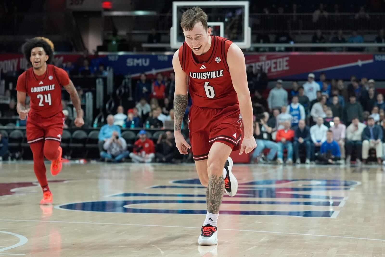 Louisville guard Reyne Smith (6) reacts to scoring a basket as teammate Chucky Hepburn (24) looks on during the second half of an NCAA college basketball game against SMU, Tuesday, Jan. 21, 2025, in Dallas. (AP Photo/LM Otero)