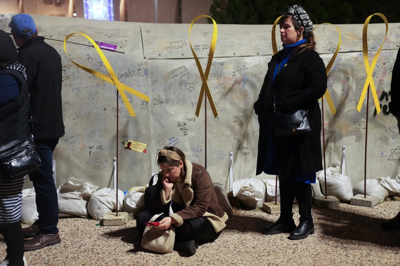 People attend a rally calling for the immediate release of the hostages held in the Gaza Strip by the Hamas militant group at a plaza known as Hostages Square in Tel Aviv, Israel, on Tuesday, Jan. 14, 2025. (AP Photo/Maya Alleruzzo)