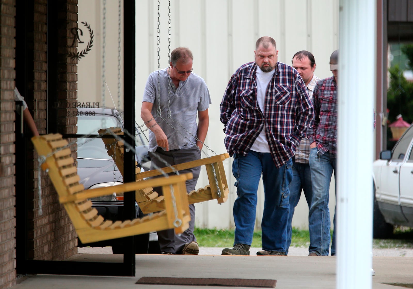 This April 27, 2016 photo,  George 'Billy' Wagner, center, and his son's George Wagner IV, in back and Jake Wagner, at right,  attend  the funeral of Gary Rhoden, 38, in Greenup, KY.  A custody dispute between two families that erupted into the massacre of eight people in rural southern Ohio started with a plan to kill just one of them, a young mother refusing to give up her daughter, a prosecutor said Monday, Oct. 4. 2022.  George Wagner IV faces the death penalty if he’s convicted in the slayings of the Rhoden family near Piketon. His younger brother, Jake Wagner, last year pleaded guilty to shooting five of the victims, and is expected to testify against his brother as part of a deal with prosecutors that spared him from being sentenced to death. (Liz Dufour/The Cincinnati Enquirer via AP)