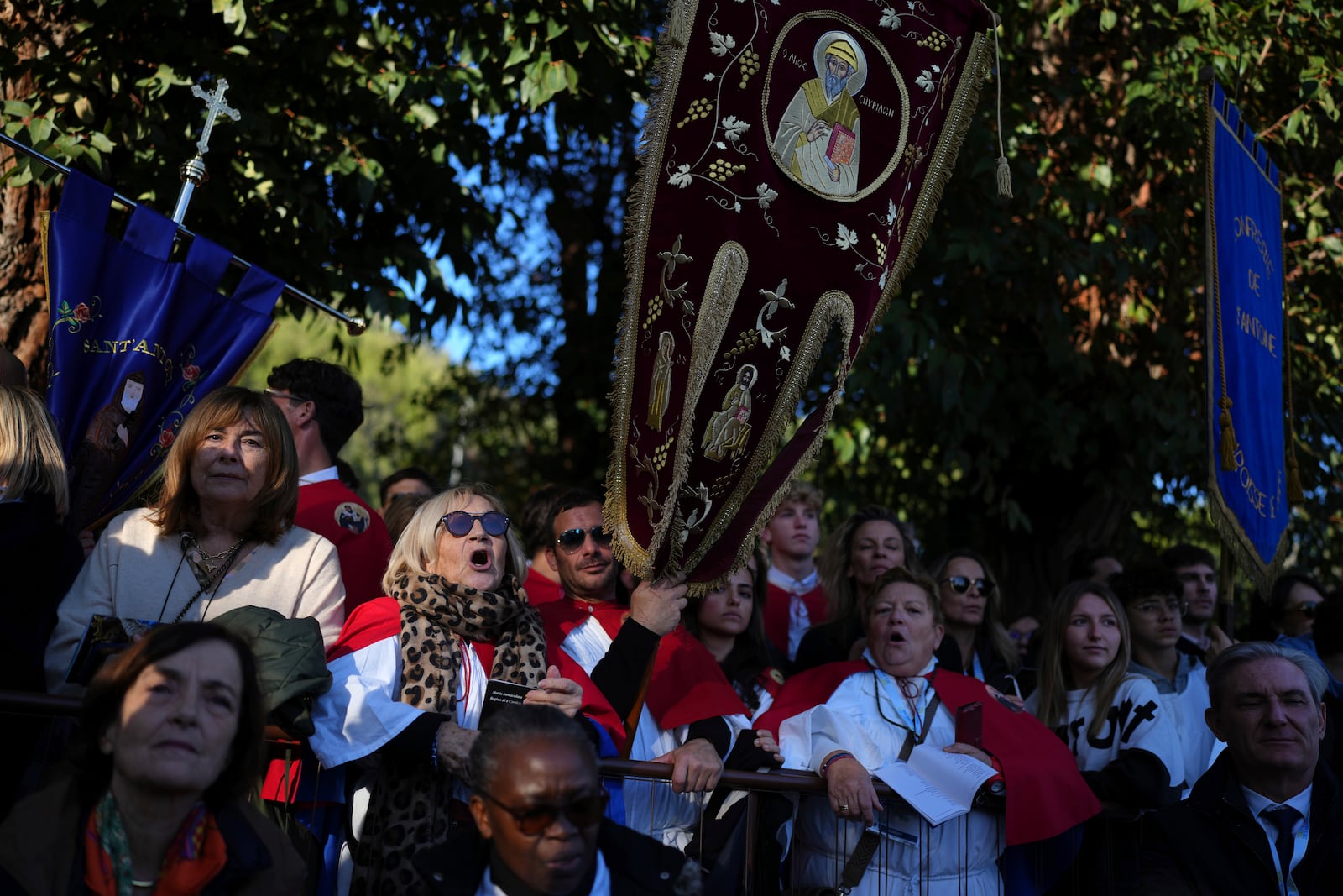 The public wait before a mass Sunday, Dec. 15, 2024 in Ajaccio, Corsica island, as Pope Francis' one-day visit to Corsica puts a dual focus on the Mediterranean, highlighting local traditions of popular piety on the one hand and migrant deaths and wars on the other. (AP Photo/Thibault Camus)