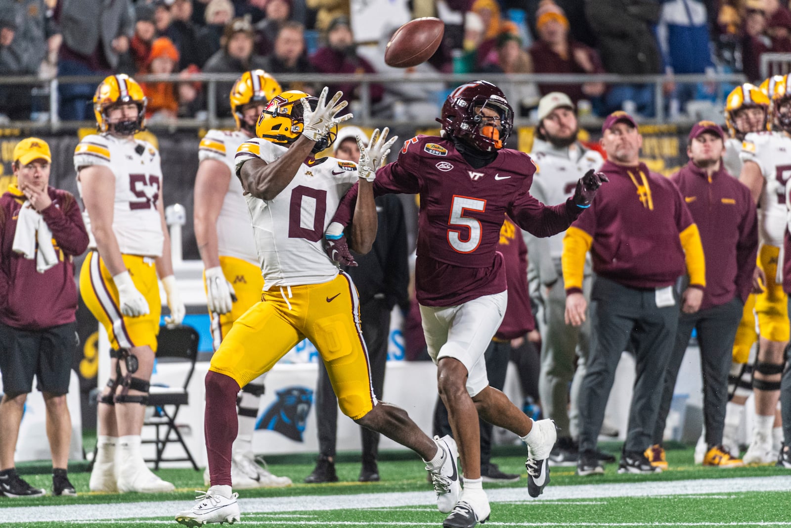 Minnesota wide receiver Le'Meke Brockington (0) makes a catch past Virginia Tech cornerback Joshua Clarke (5) during the first half of the Duke's Mayo Bowl NCAA college football game Friday, Jan. 3, 2025, in Charlotte, N.C. (AP Photo/Robert Simmons)