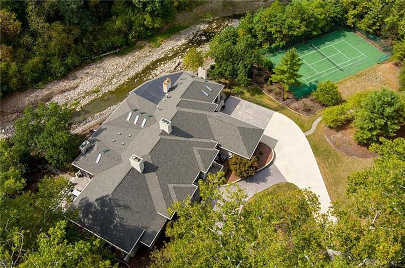 The private, gated home sits on Hole Creek and has a private tennis court