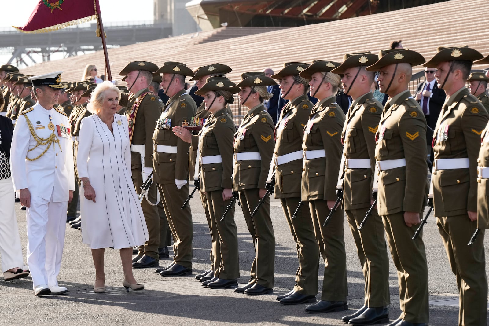 Britain's Queen Camilla inspects honor guards during their visit at the Sydney Opera House in Sydney, Australia, Tuesday, Oct. 22, 2024. (AP Photo/Mark Baker, Pool)