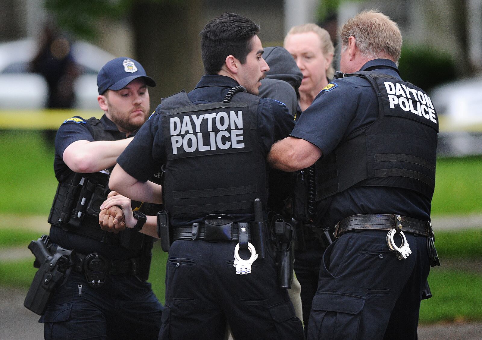 Emotions run high at a double fatal shooting on Shaftesbury Road Wednesday, May 22, 2024, as police officers hold back a family member or friend from running into the scene. MARSHALL GORBY\STAFF