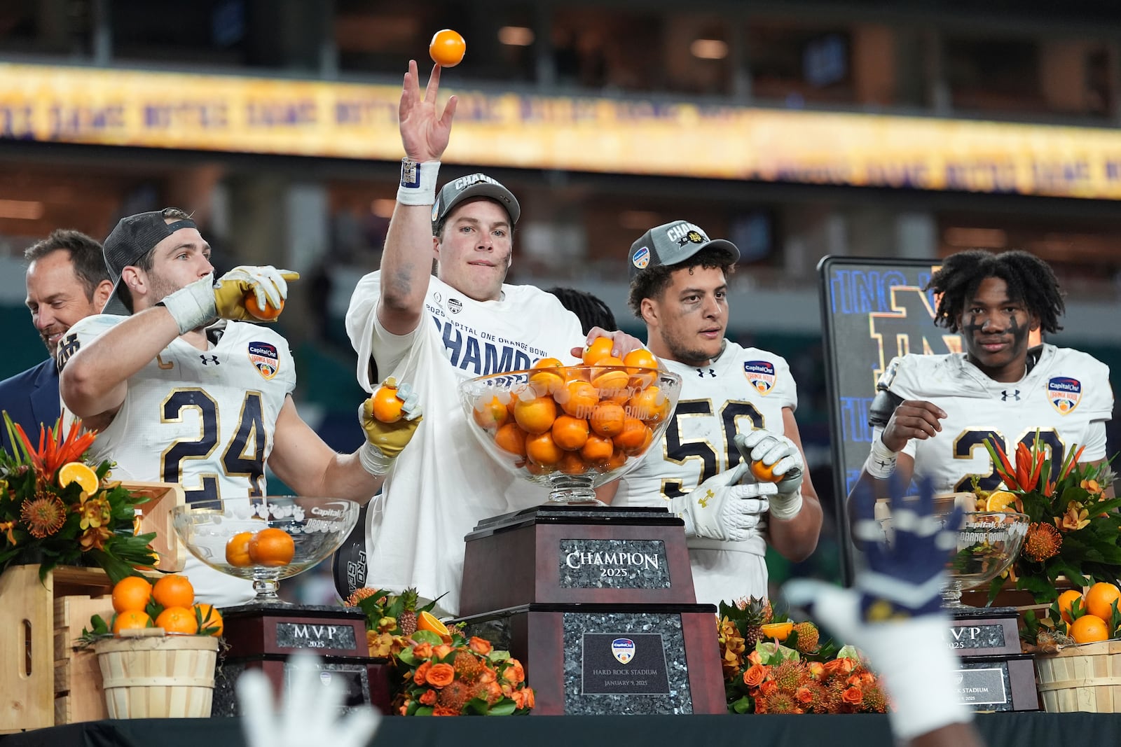 Notre Dame quarterback Riley Leonard throws oranges to his teammates after winning the Orange Bowl College Football Playoff semifinal game against Penn State, Thursday, Jan. 9, 2025, in Miami Gardens, Fla. (AP Photo/Rebecca Blackwell)