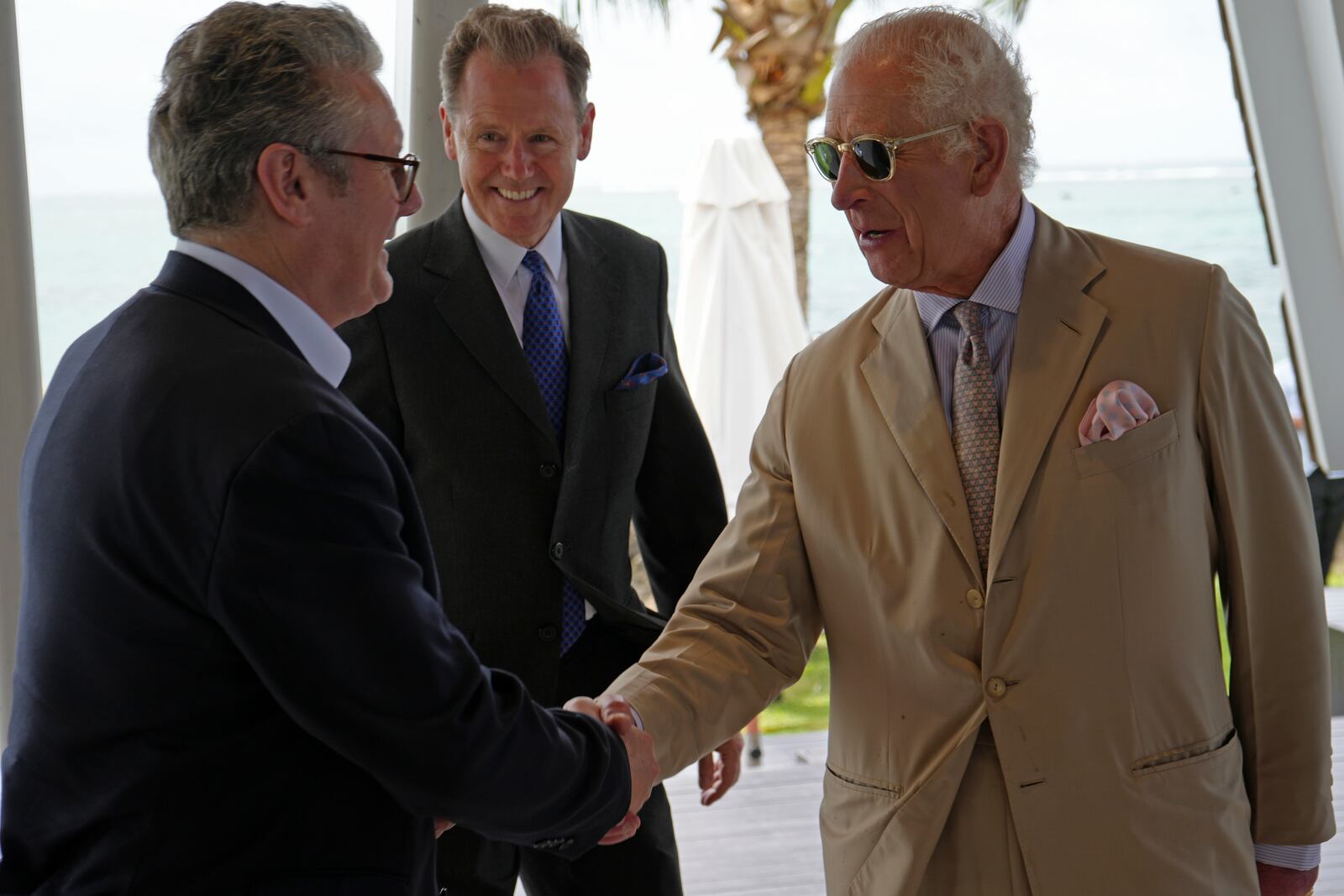 Britain's King Charles III, right, shakes hands with Britain's Prime Minister Keir Starmer at a reception the King is hosting for for heads of government and spouses/partners attending the Commonwealth Heads of Government Meeting (CHOGM) in Apia, Samoa, on Friday, Oct. 25, 2024. (Samoa CHOGM 2024/Pool Photo via AP)