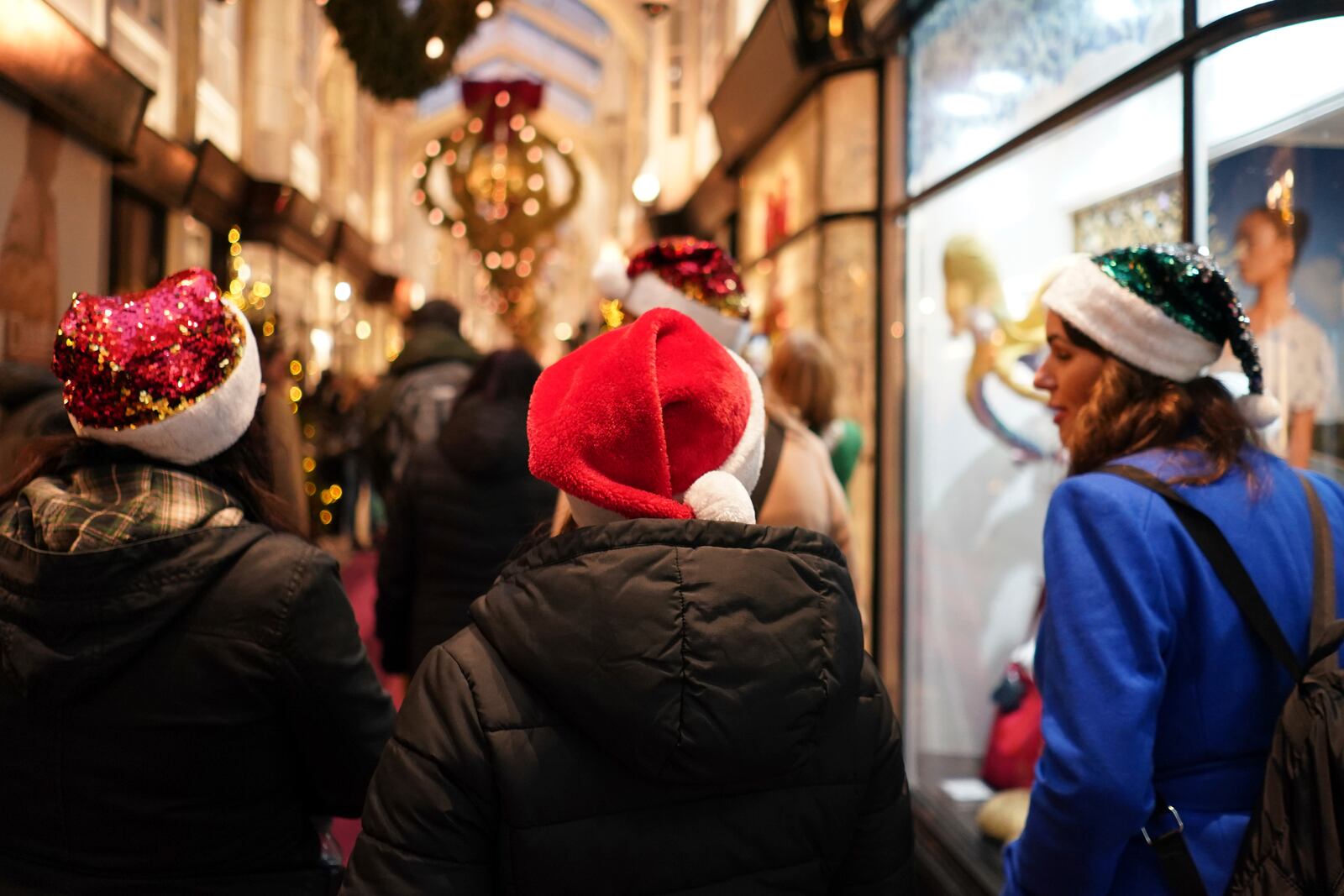 Christmas shoppers out wearing seasonal hats in central London, Friday, Dec. 13, 2024, Britain's economy unexpectedly shrank by 0.1 percent in October, The Office for National Statistics stated in figures released Friday. (AP Photo/Alberto Pezzali, Pool)