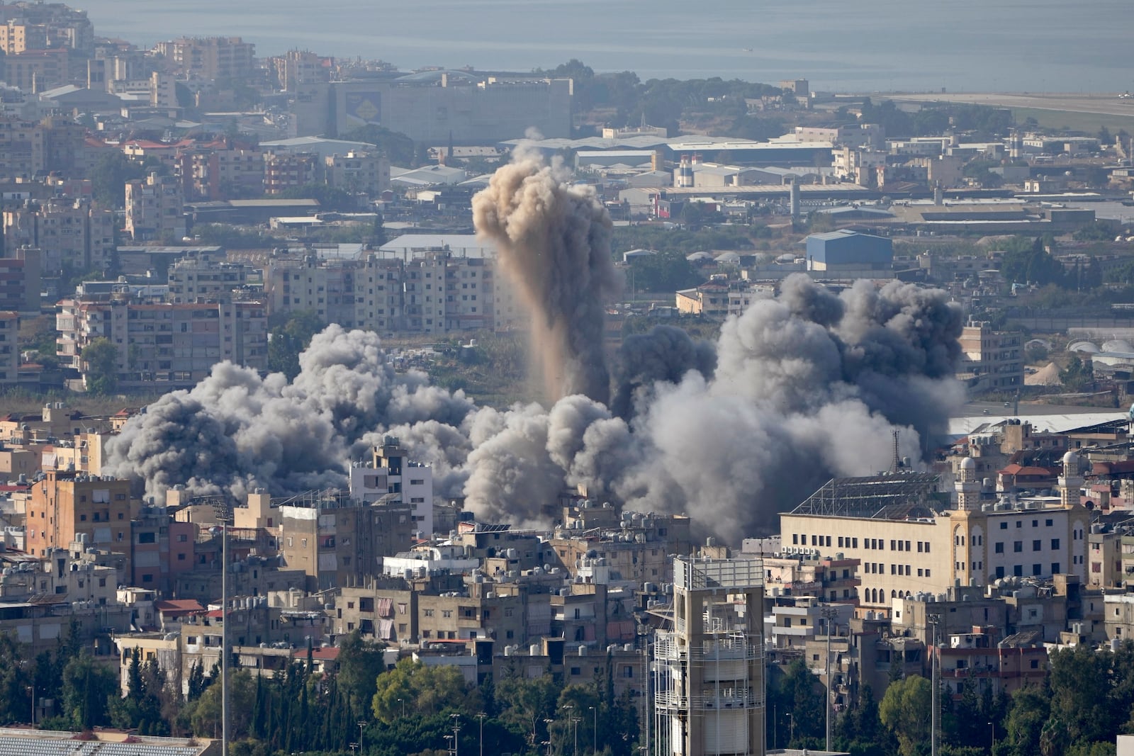 Smoke rises between buildings hit by an Israeli airstrike in Dahiyeh, the southern suburb of Beirut, Lebanon, Thursday, Nov. 14, 2024. (AP Photo/Hussein Malla)