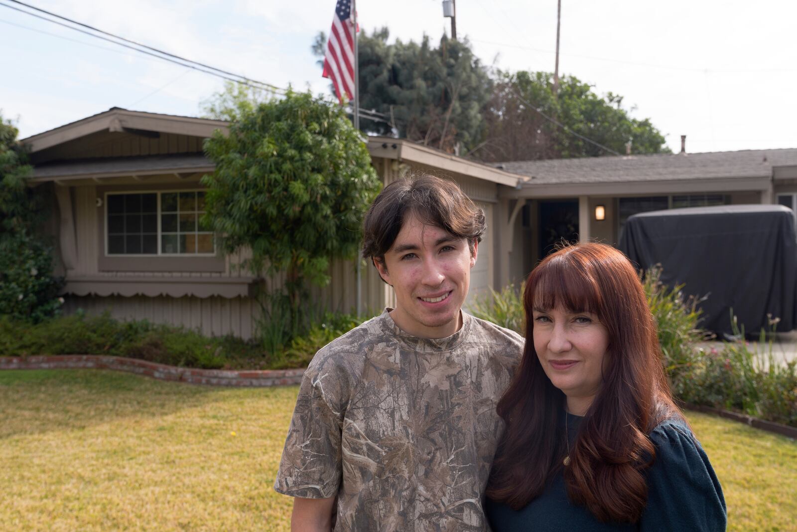 Cici Carroll and her son Jordan Carroll pose for a photo outside their home in Duarte, Calif., Friday, Jan. 31, 2025, as they express their concerns regarding the proximity of Lario Park, used by the U.S. Environmental Protection Agency (EPA), as a temporary site for processing hazardous materials from the Eaton Fire. (AP Photo/Damian Dovarganes)