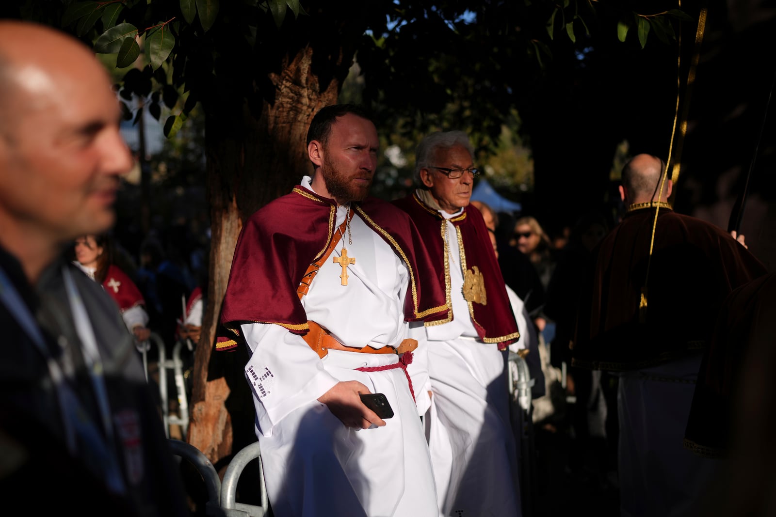 Members of a catholic local brotherhood arrive for a mass Sunday, Dec. 15, 2024 in Ajaccio, Corsica island, as Pope Francis' one-day visit to Corsica puts a dual focus on the Mediterranean, highlighting local traditions of popular piety on the one hand and migrant deaths and wars on the other. (AP Photo/Thibault Camus)