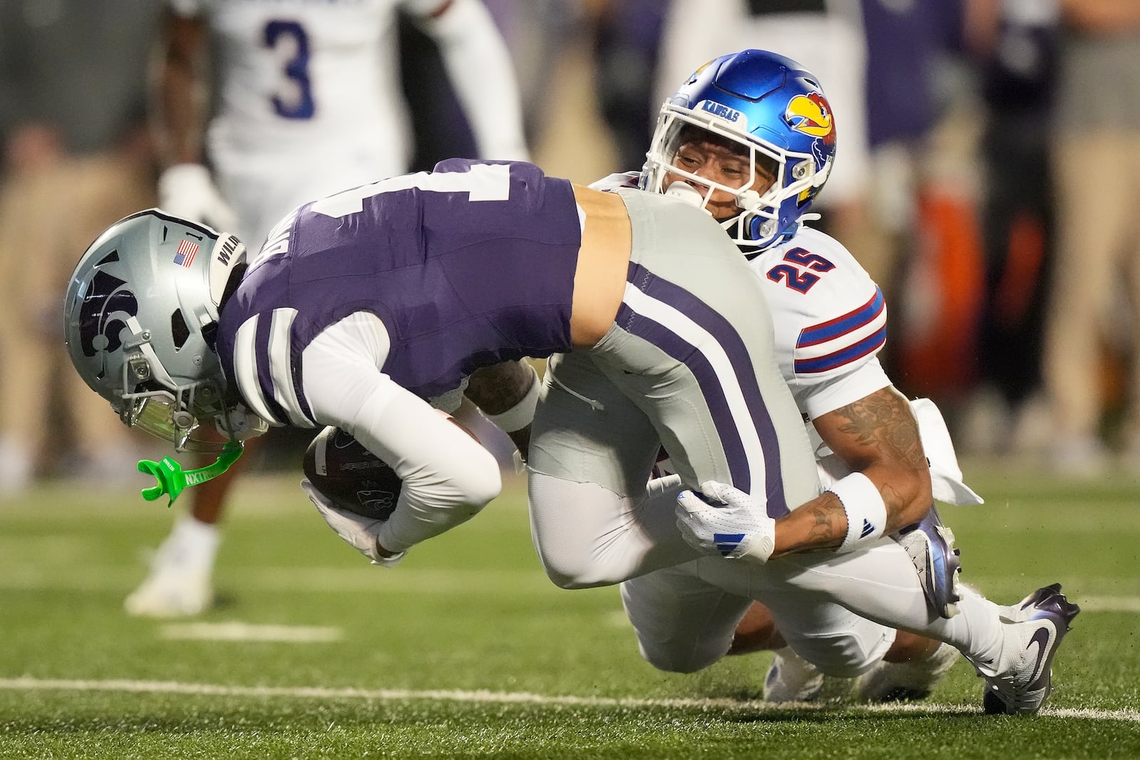 Kansas safety Kaleb Purdy (25) tackles Kansas State wide receiver Jayce Brown (1) during the first half of an NCAA college football game Saturday, Oct. 26, 2024, in Manhattan, Kan. (AP Photo/Charlie Riedel)