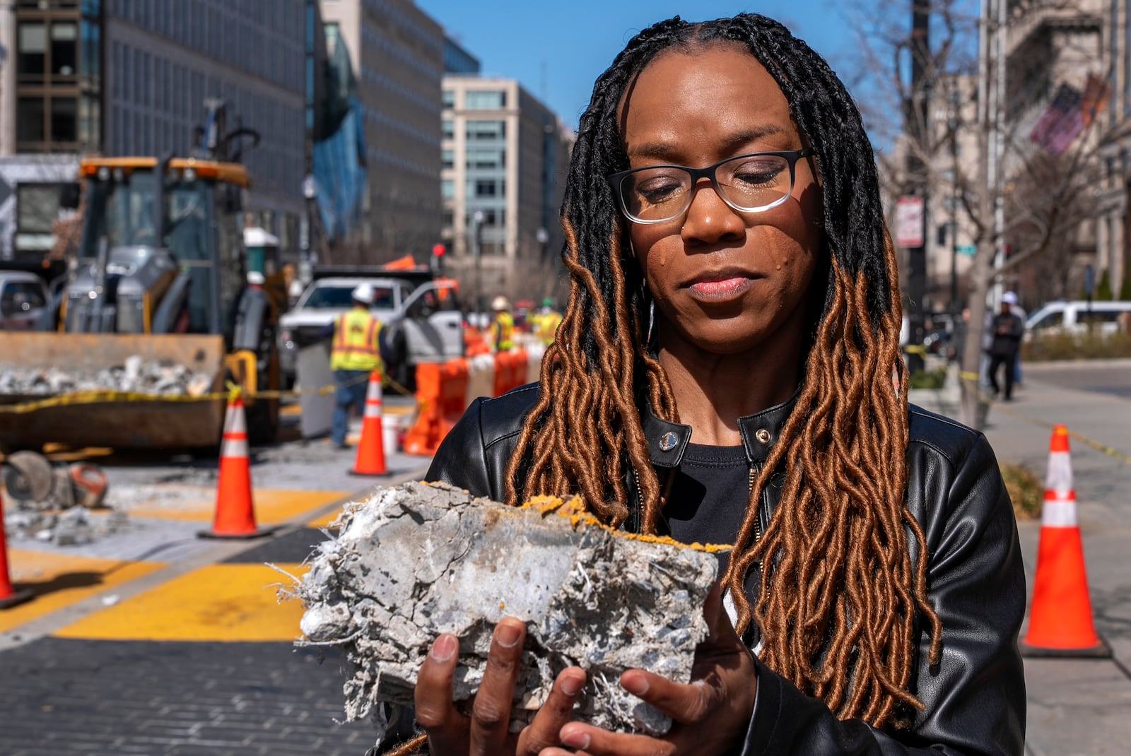 Tears roll down the face of Starlette Thomas, of Bowie, Md., as she holds a chunk of pavement from the Black Lives Matter mural, Monday, March 10, 2025, as the mural begins to be demolished in Washington. "I needed to be here to bear witness," says Thomas, who was present at the 2020 George Floyd protests. "For me the Black Lives Matter sign etched in stone was a declaration of somebodyness and to watch it be undone in this way was very hurtful. To walk away with a piece of that, it means it's not gone. It's more than brick and mortar." (AP Photo/Jacquelyn Martin)