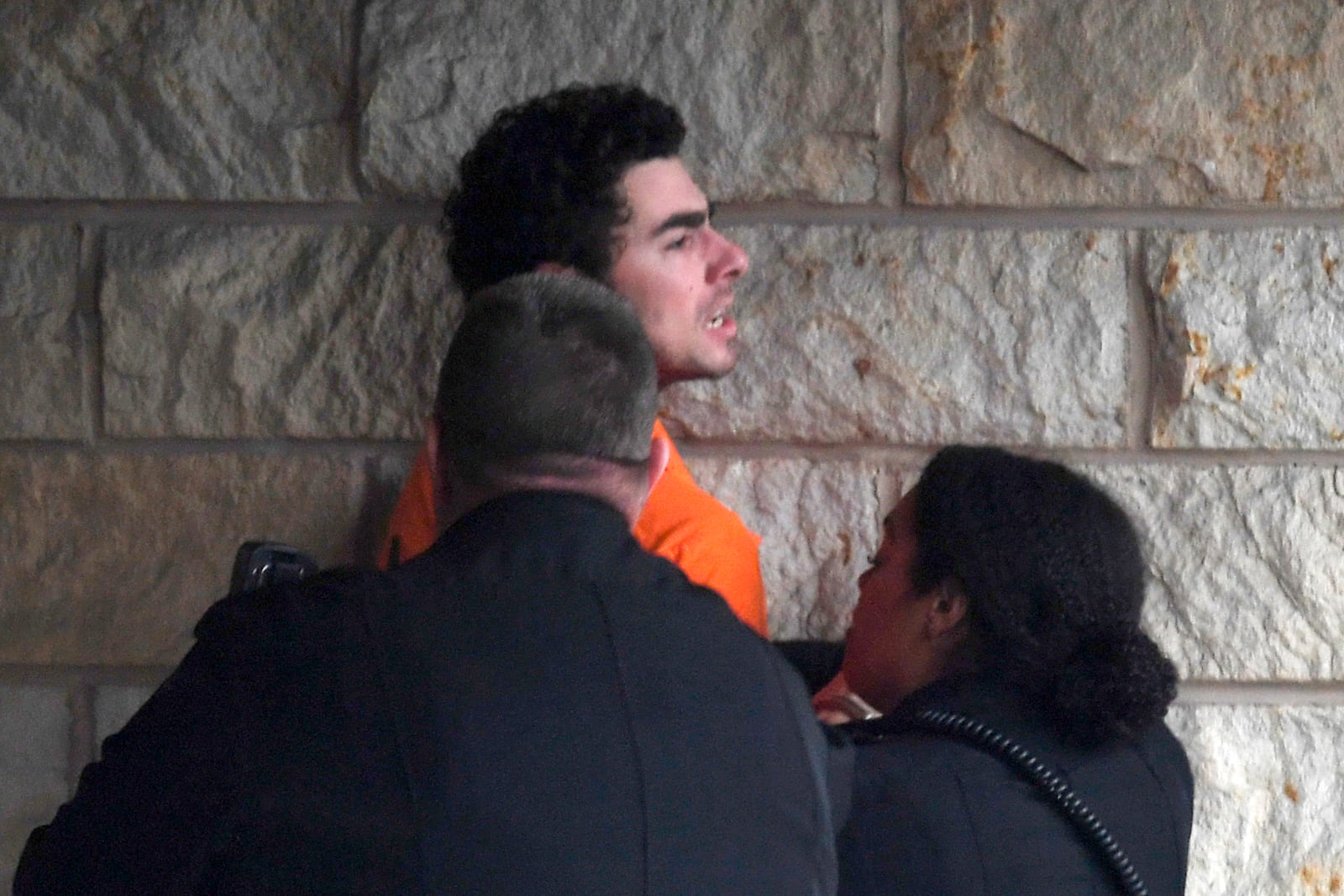 Luigi Nicholas Mangione is escorted into Blair County Courthouse, Tuesday, Dec. 10, 2024, in Hollidaysburg, Pa. (AP Photo/Gary M. Baranec)