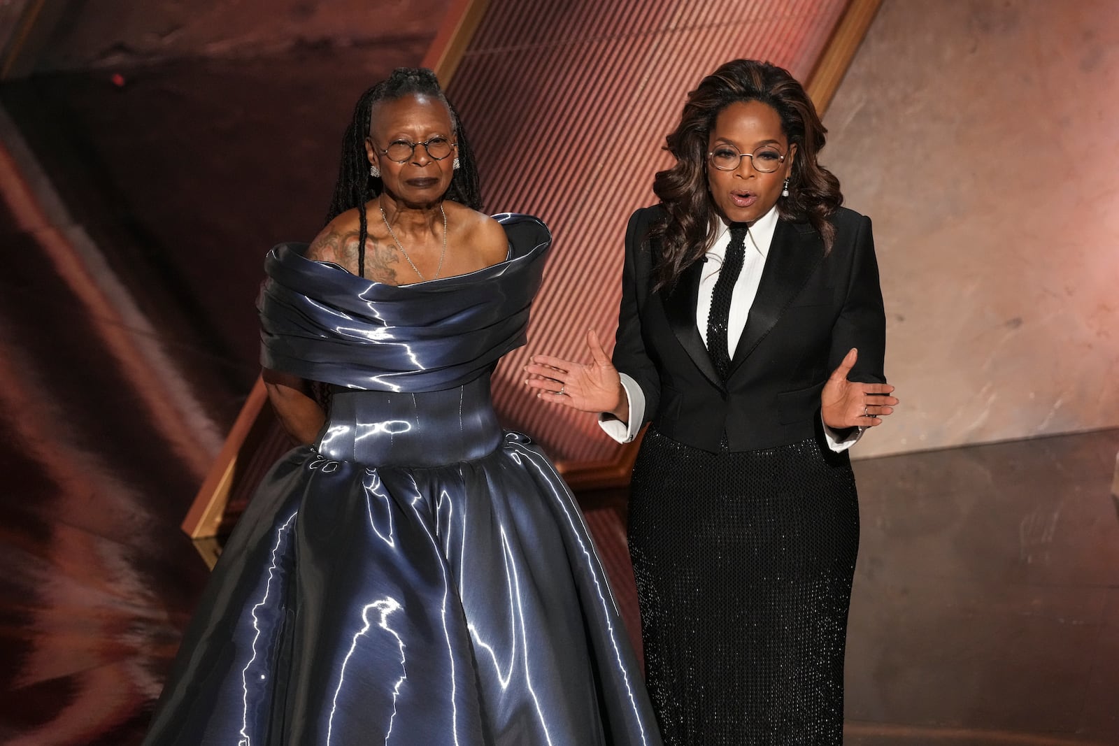 Whoopi Goldberg, left, and Oprah pay tribute to Quincy Jones during the Oscars on Sunday, March 2, 2025, at the Dolby Theatre in Los Angeles. (AP Photo/Chris Pizzello)