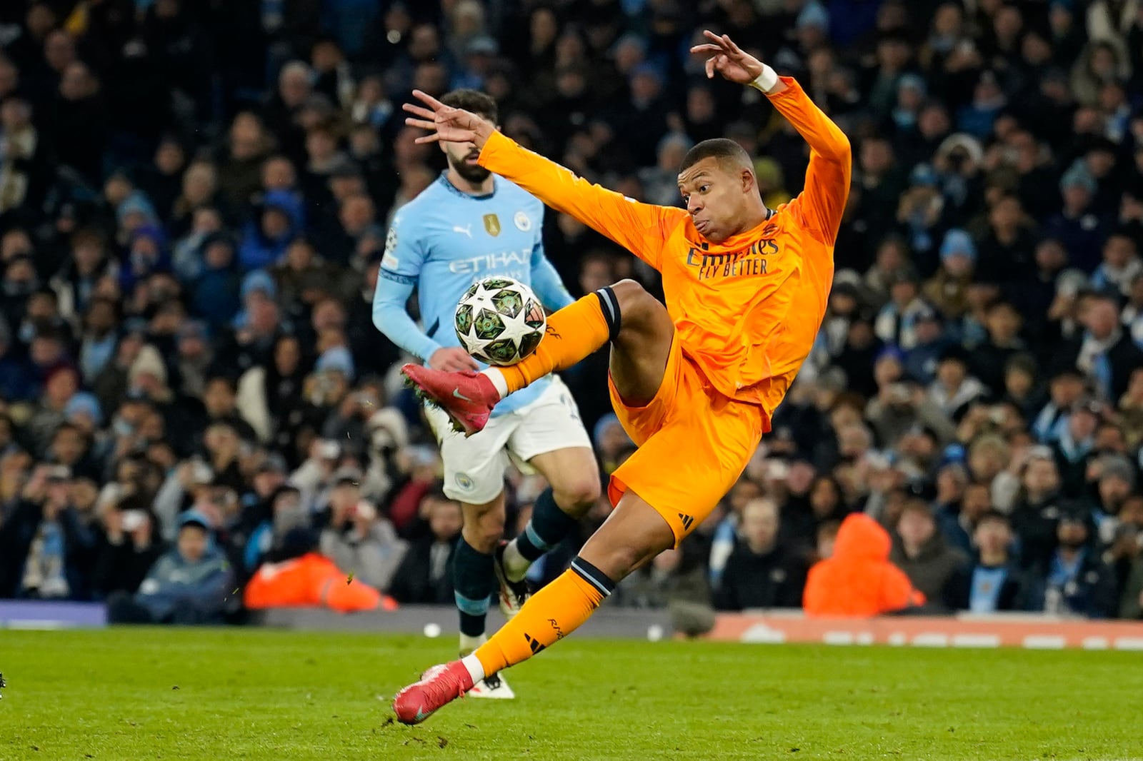 Real Madrid's Kylian Mbappe scores his sides first goal during the Champions League playoff first leg soccer match between Manchester City and Real Madrid at the Etihad Stadium in Manchester, England, Tuesday, Feb. 11, 2025. (AP Photo/Dave Thompson)