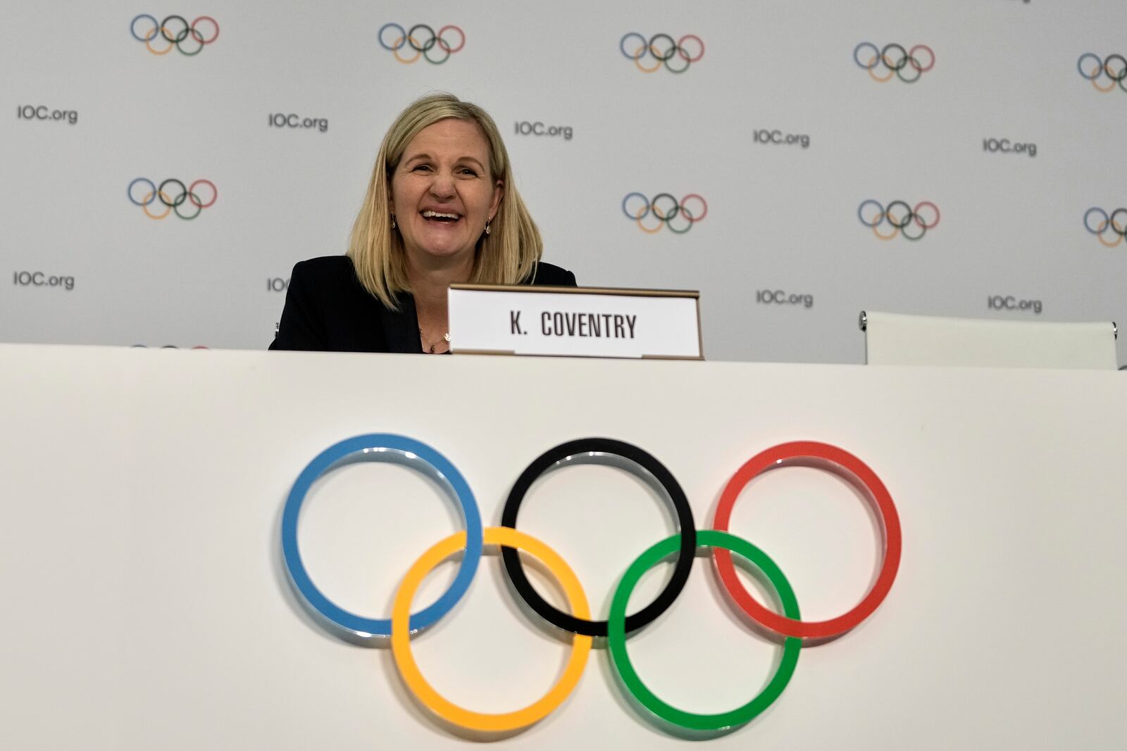 Kirsty Coventry laughs during a press conference after she was elected as the new IOC President at the International Olympic Committee 144th session in Costa Navarino, western Greece, Thursday, March 20, 2025. (AP Photo/Thanassis Stavrakis)