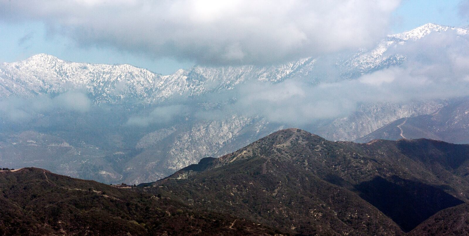 FILE - The San Gabriel Mountain range is covered in snow, Thursday Oct. 10, 2013, in Walnut, Calif. (AP Photo/Damian Dovarganes, File)