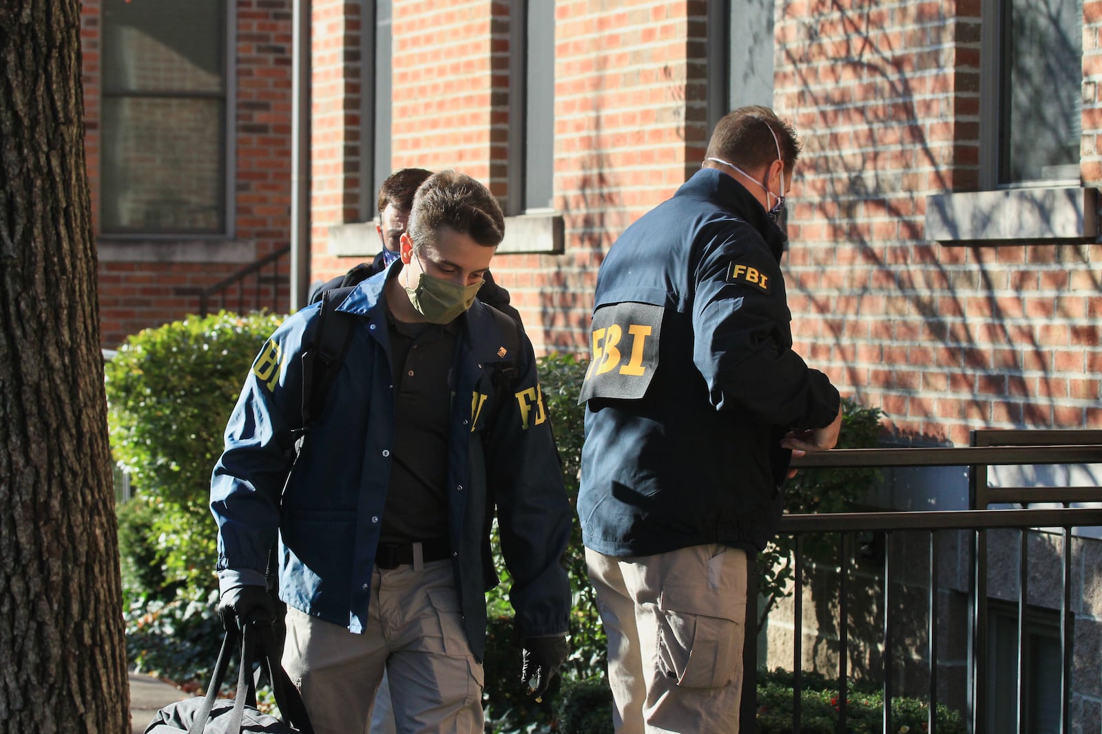 Federal agents bring out boxes after searching a Columbus condo owned by Sam Randazzo, chairman of the Public Utilities Commission of Ohio, on Monday, Nov. 16, 2020, in Columbus. David Jablonski/Staff