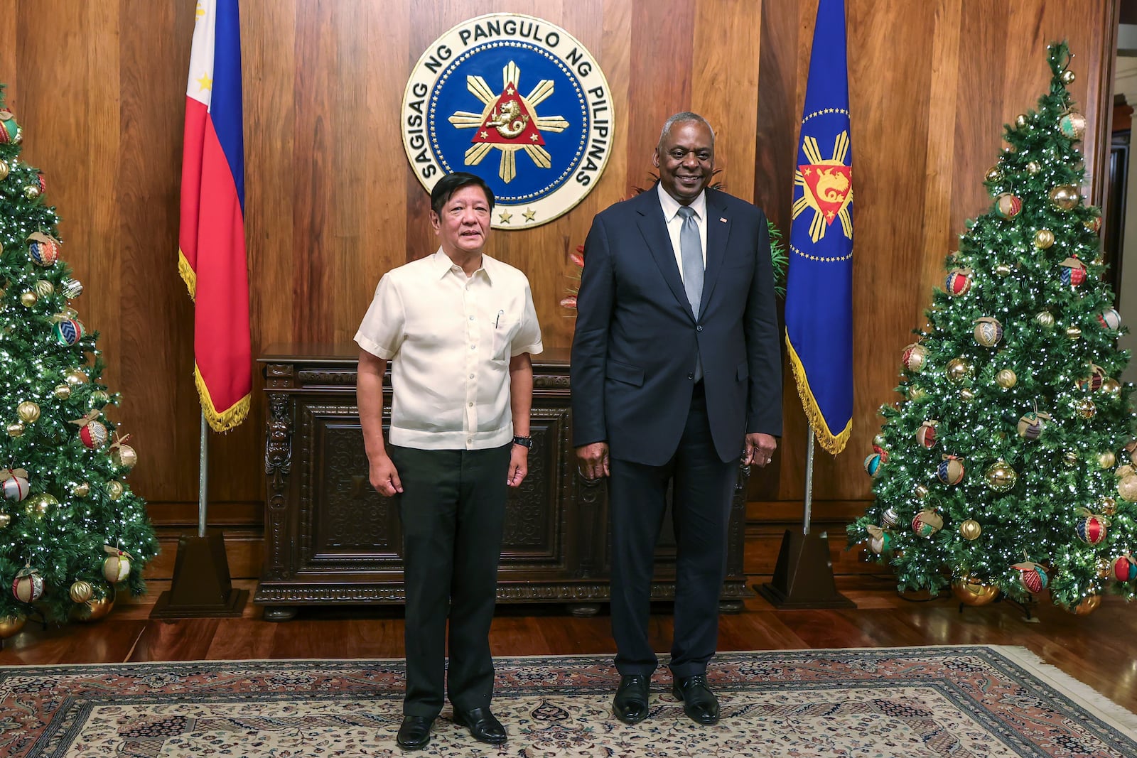 U.S. Defense Secretary Lloyd Austin, right, and Philippine President Ferdinand Marcos Jr. pose for a photograph during a courtesy call at the Malacanang Palace in Manila, Philippines Monday, Nov. 18, 2024. (AP Photo/Gerard Carreon, Pool)