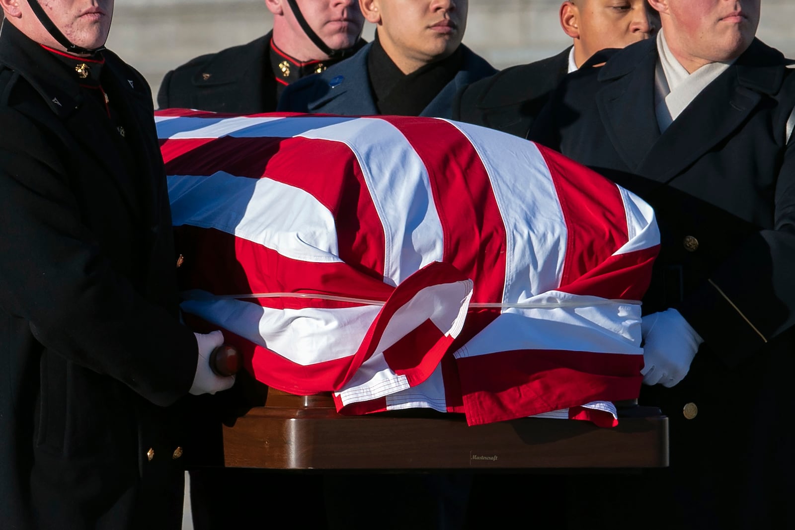 A joint services military body bearer team carries the flag-draped casket of former President Jimmy Carter from the U.S. Capitol on the way to a state funeral at the National Cathedral in Washington, Thursday, Jan. 9, 2025. (AP Photo/Jose Luis Magana)