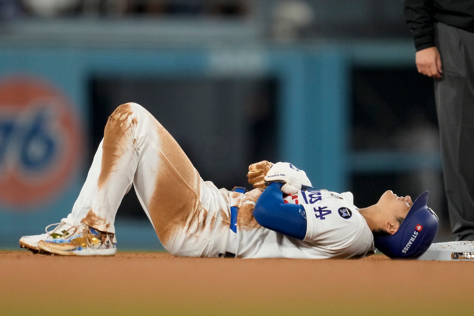 Los Angeles Dodgers' Shohei Ohtani is gets hurt sliding into second base during the seventh inning in Game 2 of the baseball World Series against the New York Yankees, Saturday, Oct. 26, 2024, in Los Angeles. (AP Photo/Ashley Landis)