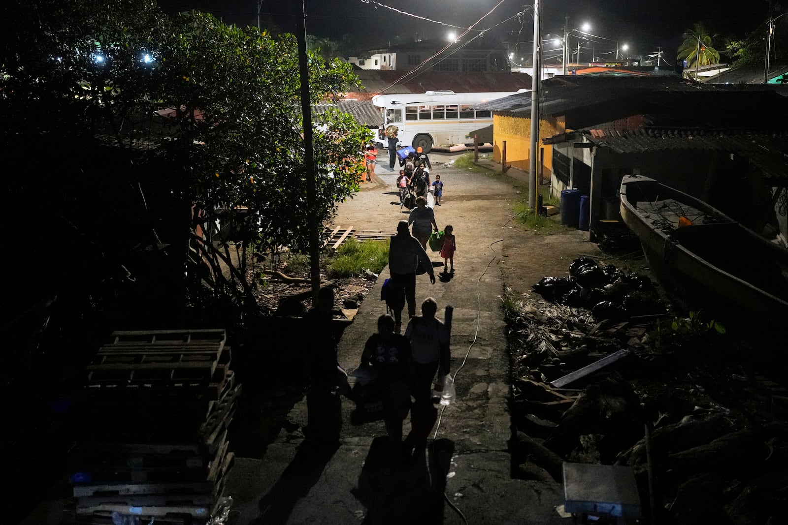 Migrants arrive to board a boat in the Caribbean coastal village of Miramar, Panama, bound for the Colombian border, Thursday, Feb. 27, 2025, as migrants return from southern Mexico after abandoning hopes of reaching the U.S. in a reverse flow triggered by the Trump administration's immigration crackdown. (AP Photo/Matias Delacroix)