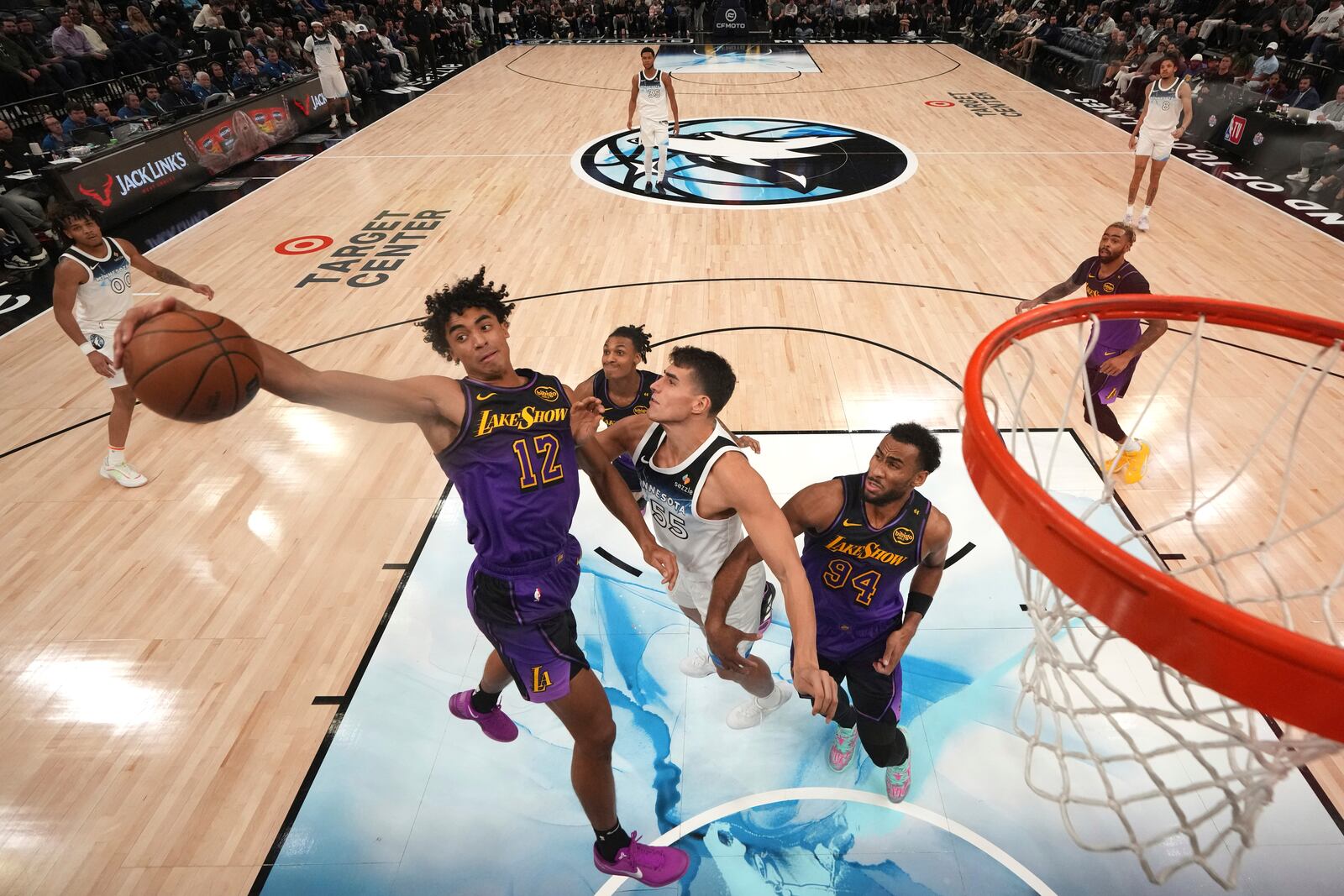 Los Angeles Lakers guard Max Christie (12) reaches for a rebound against Minnesota Timberwolves center Luka Garza (55) during the second half of an NBA basketball game, Monday, Dec. 2, 2024, in Minneapolis. (AP Photo/Abbie Parr)