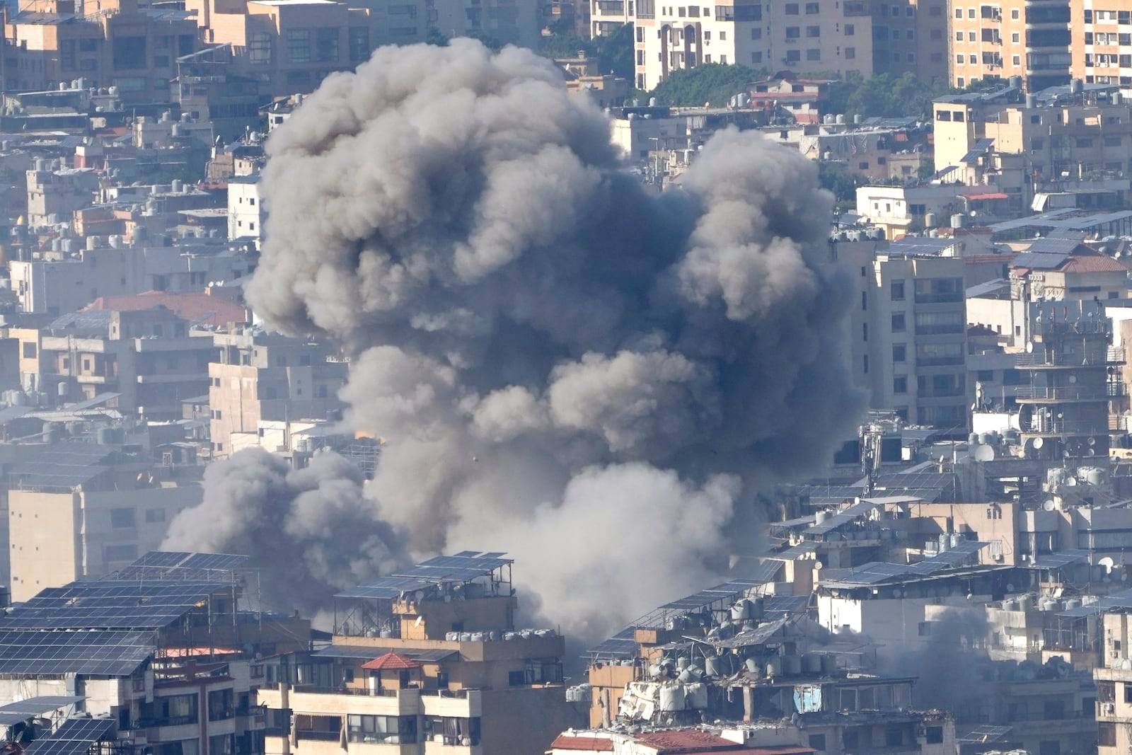 Smoke rises between buildings hit in an Israeli airstrike in Dahiyeh, in the southern suburb of Beirut, Lebanon, Thursday, Nov. 14, 2024. (AP Photo/Hussein Malla)