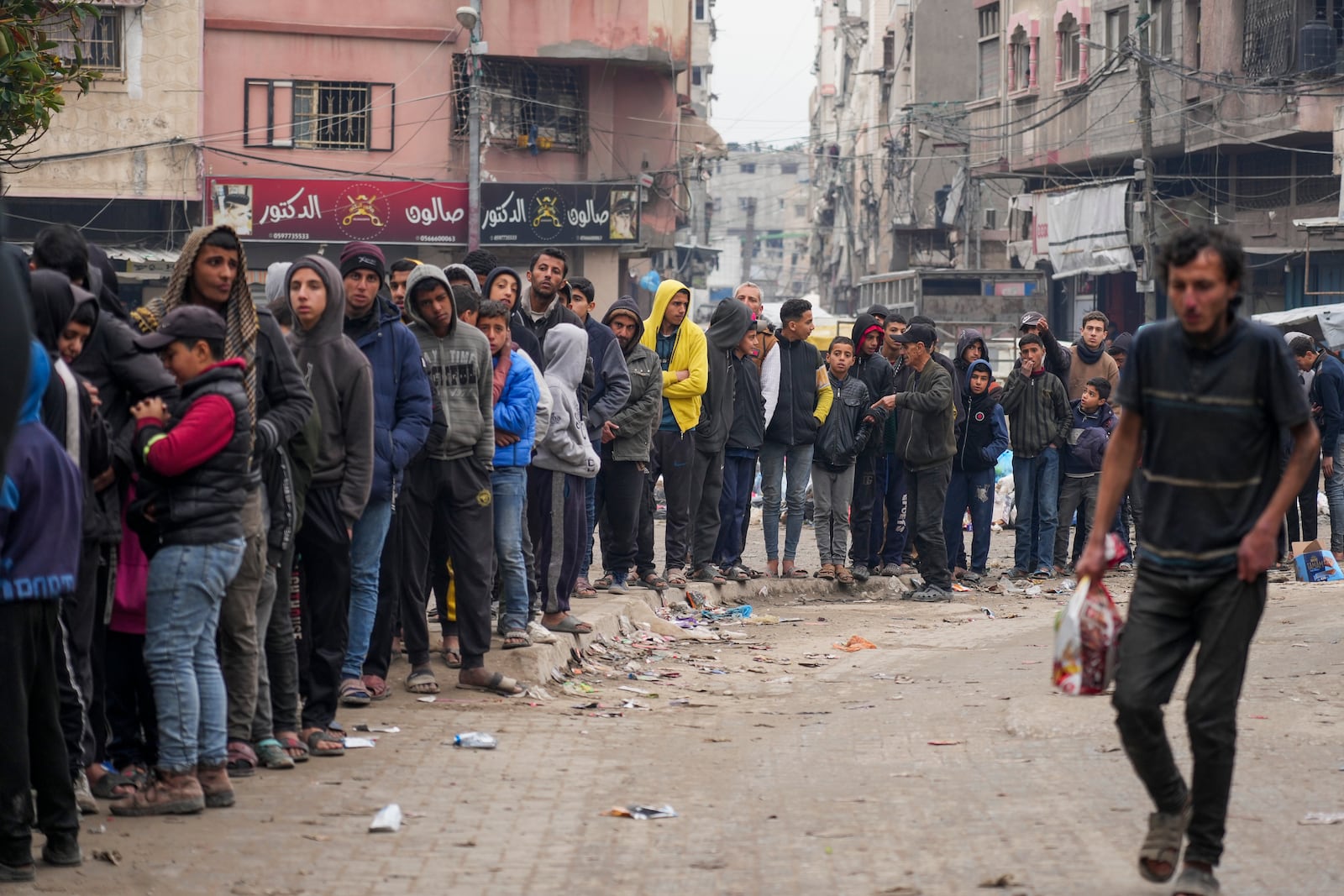 Palestinians queue to purchase bread outside a bakery in Gaza City, Monday, Feb. 24, 2025. (AP Photo/Abdel Kareem Hana)