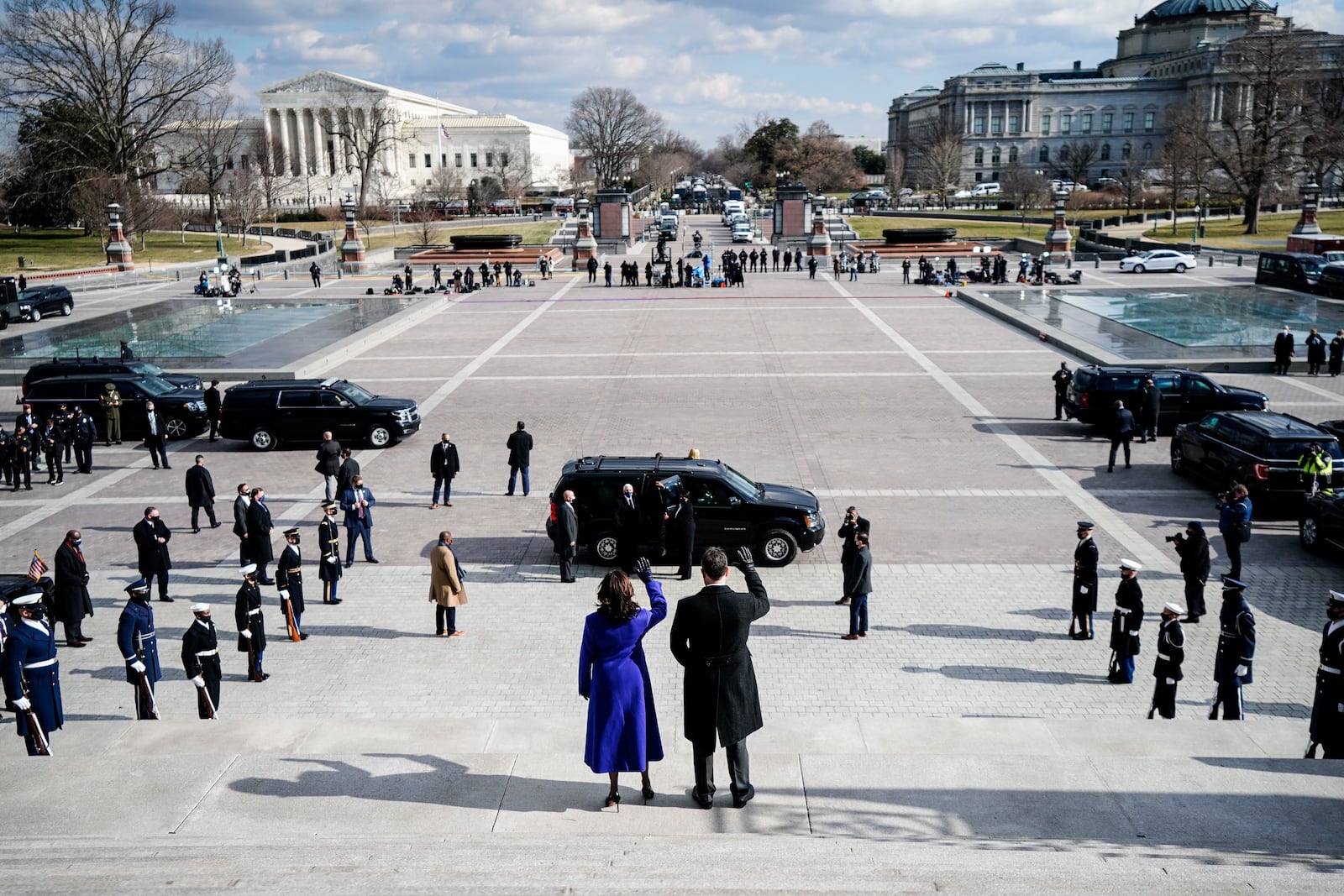 FILE - Vice President Kamala Harris and her husband Doug Emhoff, wave from the Capitol steps as former Vice President Mike Pence gets into a vehicle following the inauguration of President Joe Biden at the U.S. Capitol in Washington, Jan. 20, 2021. (Melina Mara/AP File)