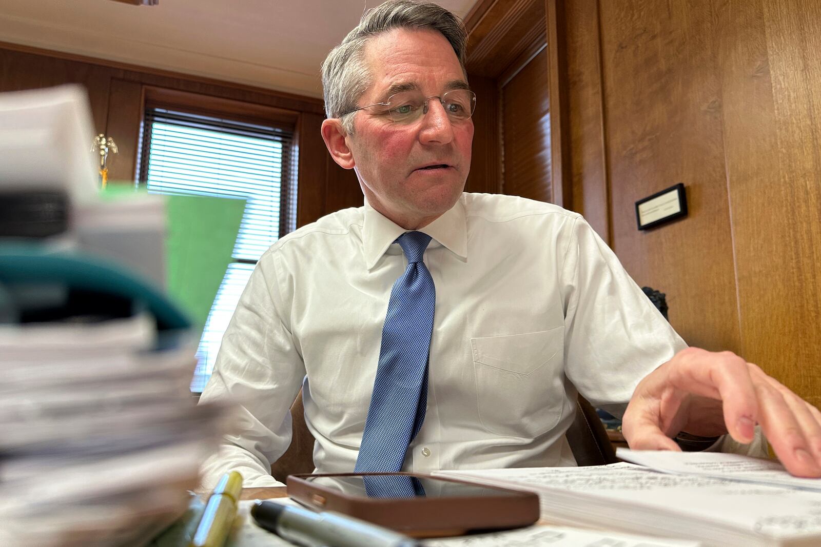 North Dakota Republican Attorney General Drew Wrigley looks over papers in his office on Monday, Jan. 6, 2025, at the state Capitol in Bismarck, N.D. (AP Photo/Jack Dura)