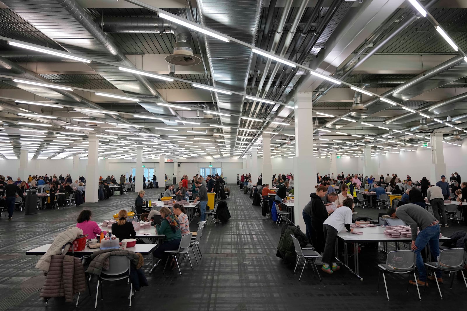 Volunteers prepare postal votes during the German national election in Munich, Germany, Sunday, Feb. 23, 2025. (AP Photo/Matthias Schrader)