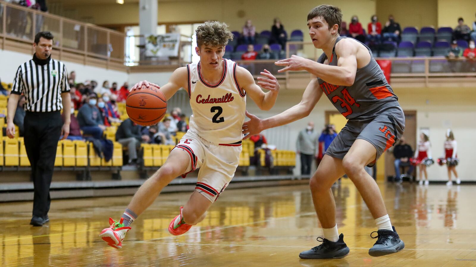 Cedarville High School senior Trent Koning drives past Jackson Center sophomore Camdyn Reese during their Division IV district final game on Saturday afternoon at the Vandalia Butler Student Activity Center. Koning scored a career-high 30 points as the Indians won their first district championship since 2005. Michael Cooper/CONTRIBUTED