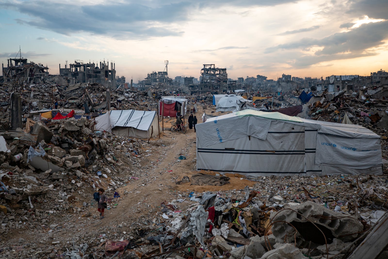 Palestinians walk in the destruction caused by the Israeli air and ground offensive in Jabaliya, Gaza Strip, Tuesday, Feb. 11, 2025. (AP Photo/Jehad Alshrafi)