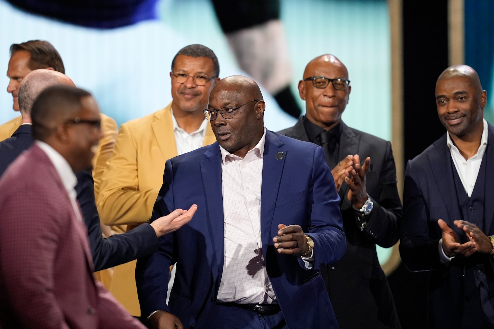 Sterling Sharpe, center, former professional football player as he is introduced into the NFL Hall of Fame Class of 2025, during the NFL Honors award show ahead of the Super Bowl 59 football game, Thursday, Feb. 6, 2025, in New Orleans. (AP Photo/David J. Phillip)