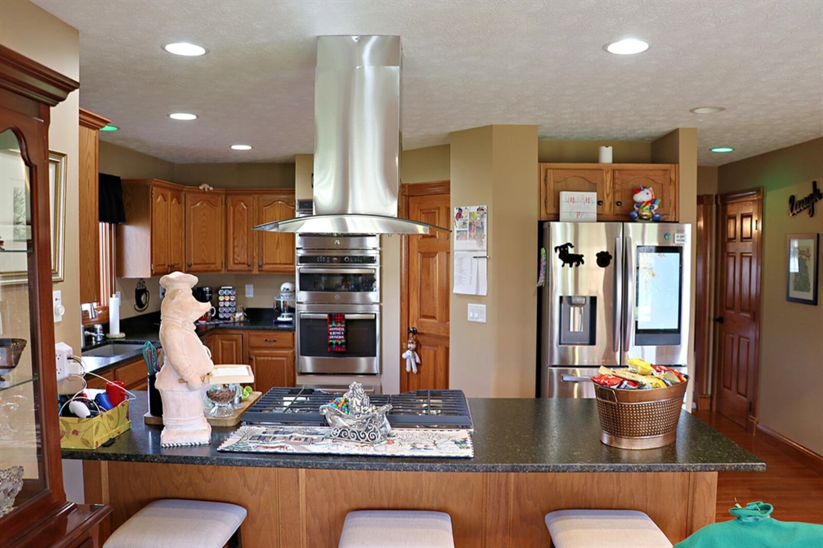 A peninsula counter divides the kitchen from the dining area. Leathered-granite counters complement the oak cabinetry that fills the kitchen. Contributed by Kathy Tyler 